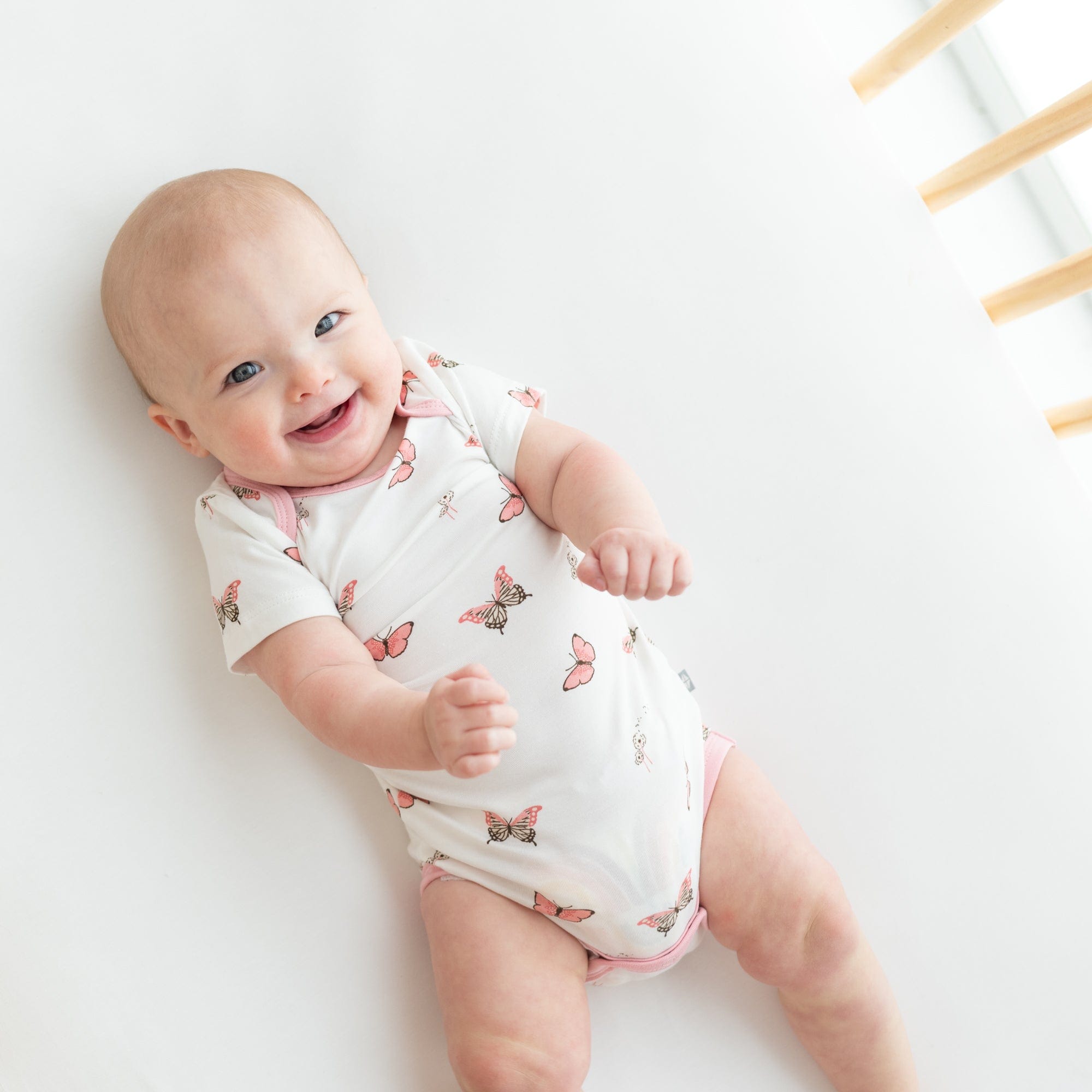 Baby wearing Kyte Baby infant Bodysuit in Butterfly