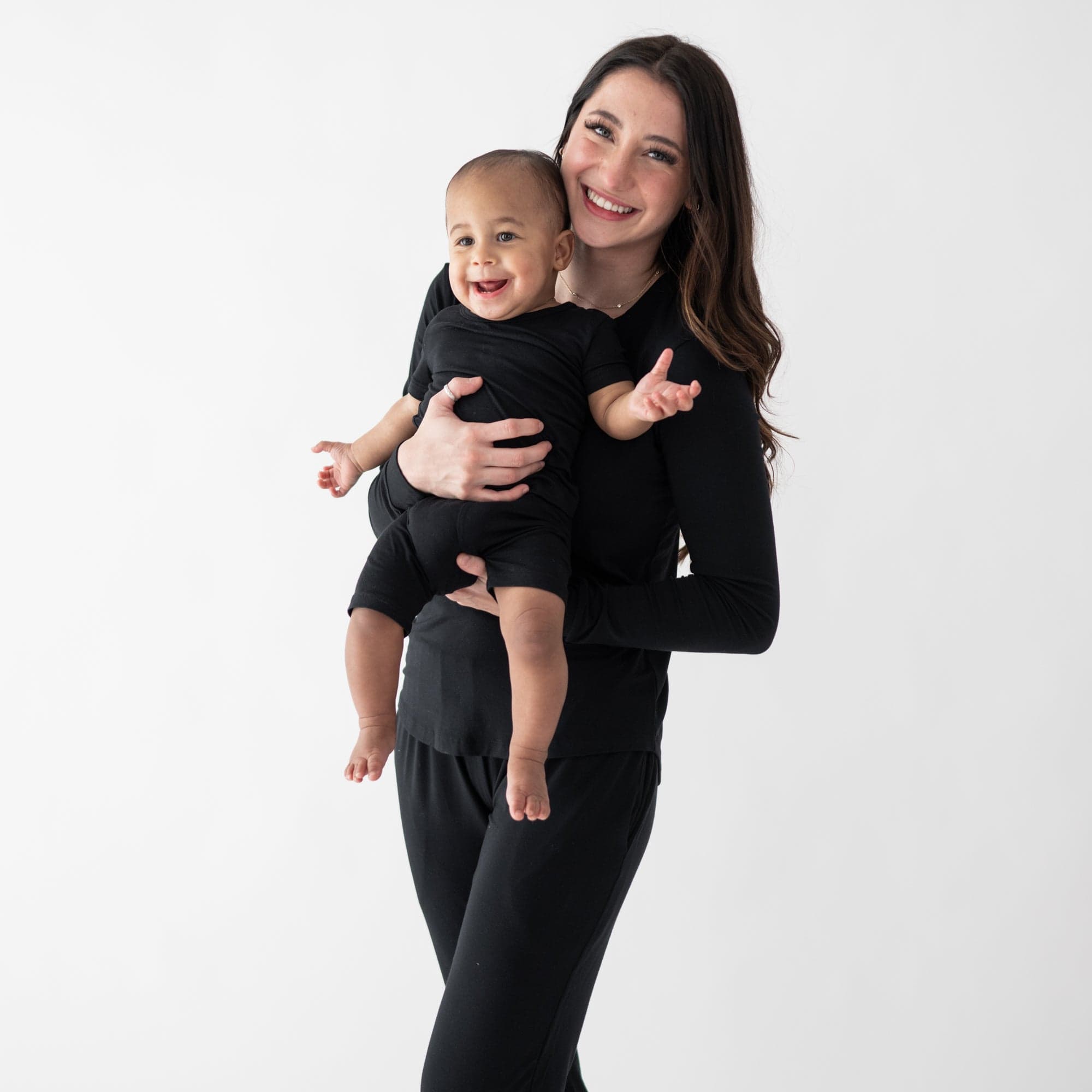 Mom and Baby wearing matching family pajamas in Black