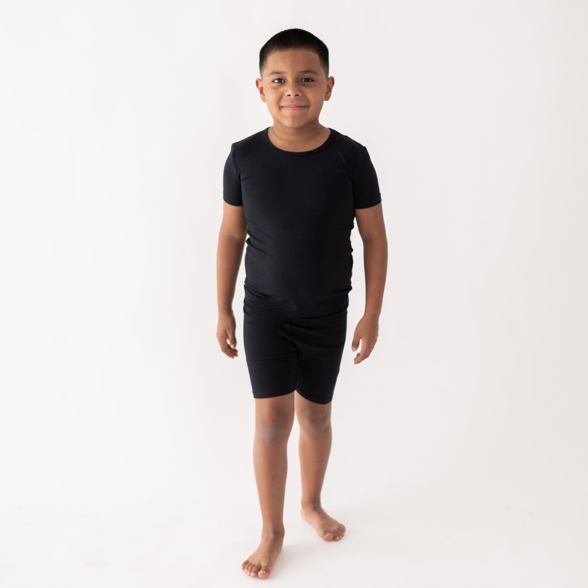 Child wearing two piece Short Sleeve Kids Pajama Set in Midnight
