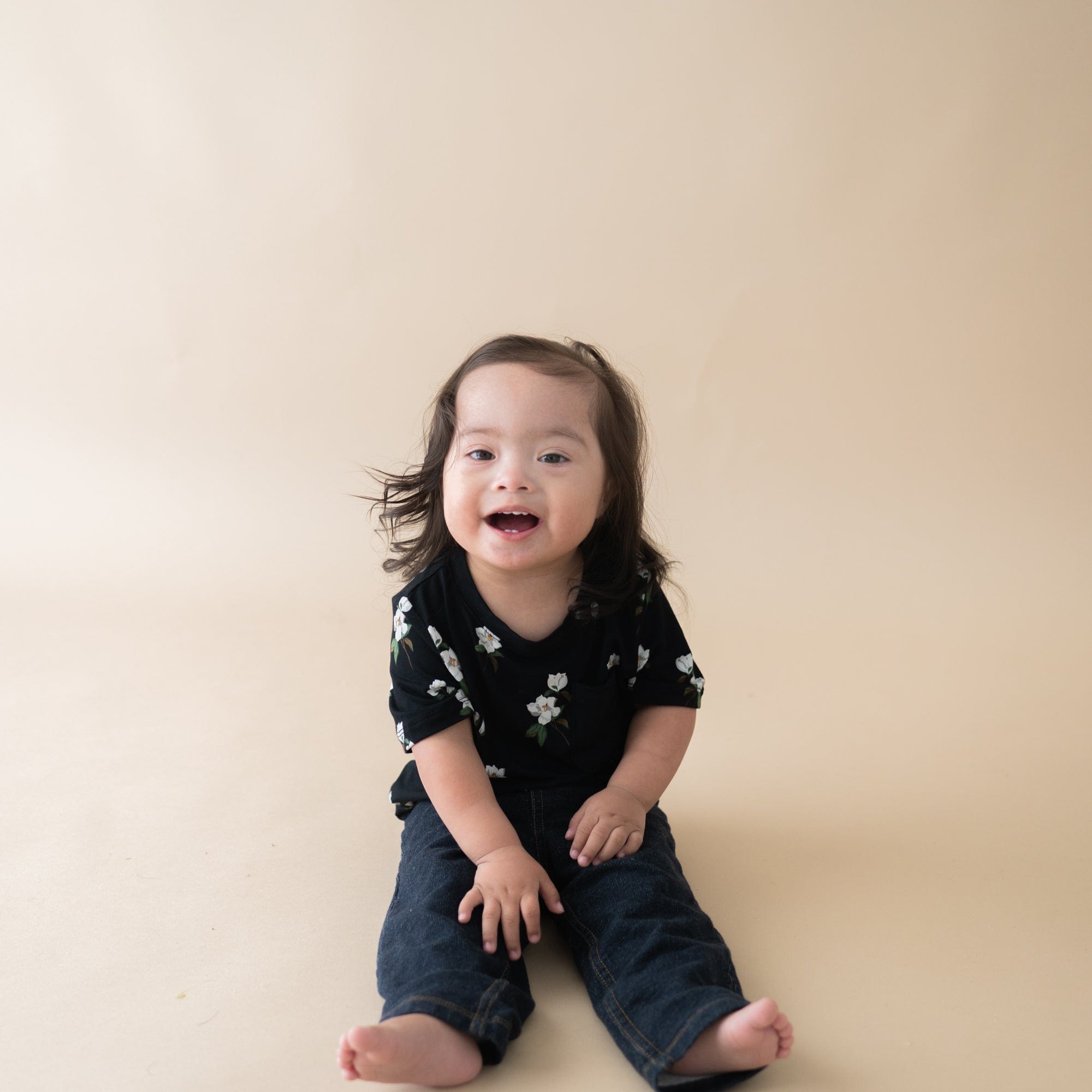 Child wearing Kyte Baby Toddler Crew Neck Tee with chest pocket in Small Midnight Magnolia