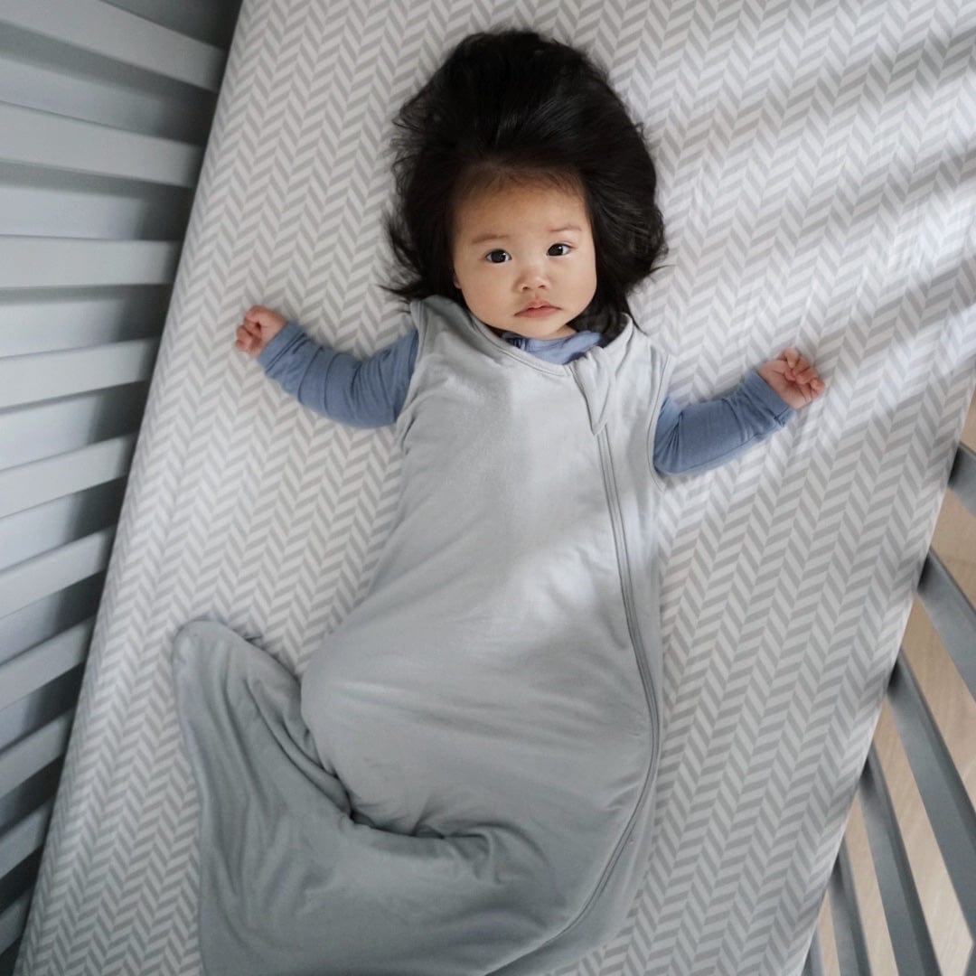 Child wearing Kyte Baby Sleep Bag in Storm 0.5