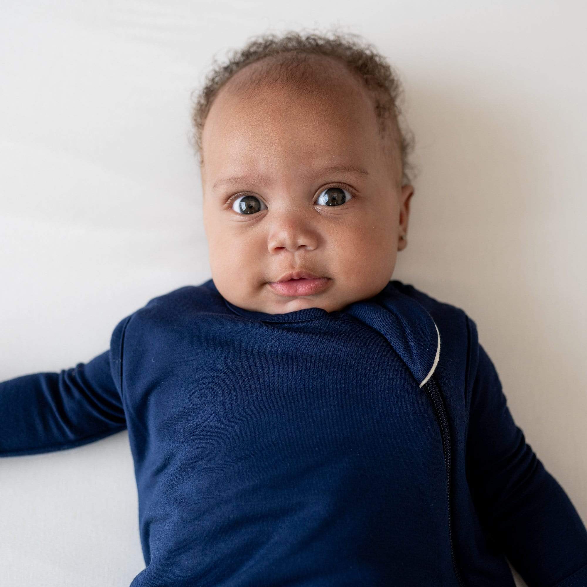 Close up of baby wearing Kyte Baby Sleep Bag 1.0 in Navy