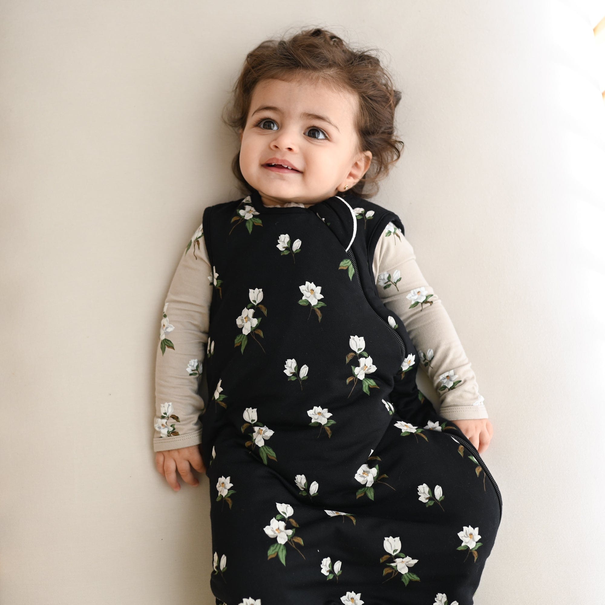 Baby wearing Kyte Baby bamboo TOG 1.0 Sleep Bag in Small Midnight Magnolia