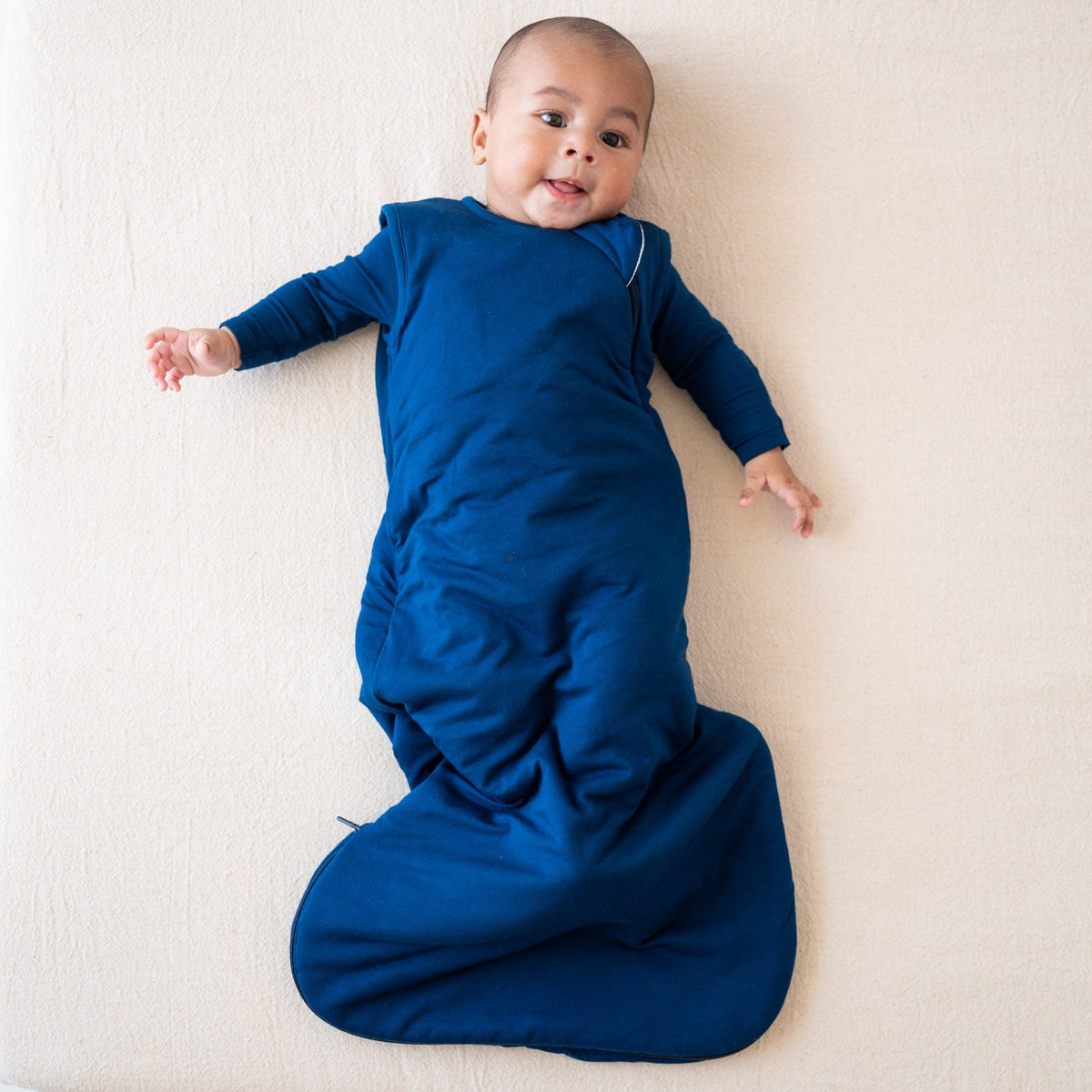 Baby wearing Kyte Baby Sleep 2.5 TOG Bag in Tahoe with a Tahoe long sleeve romper underneath