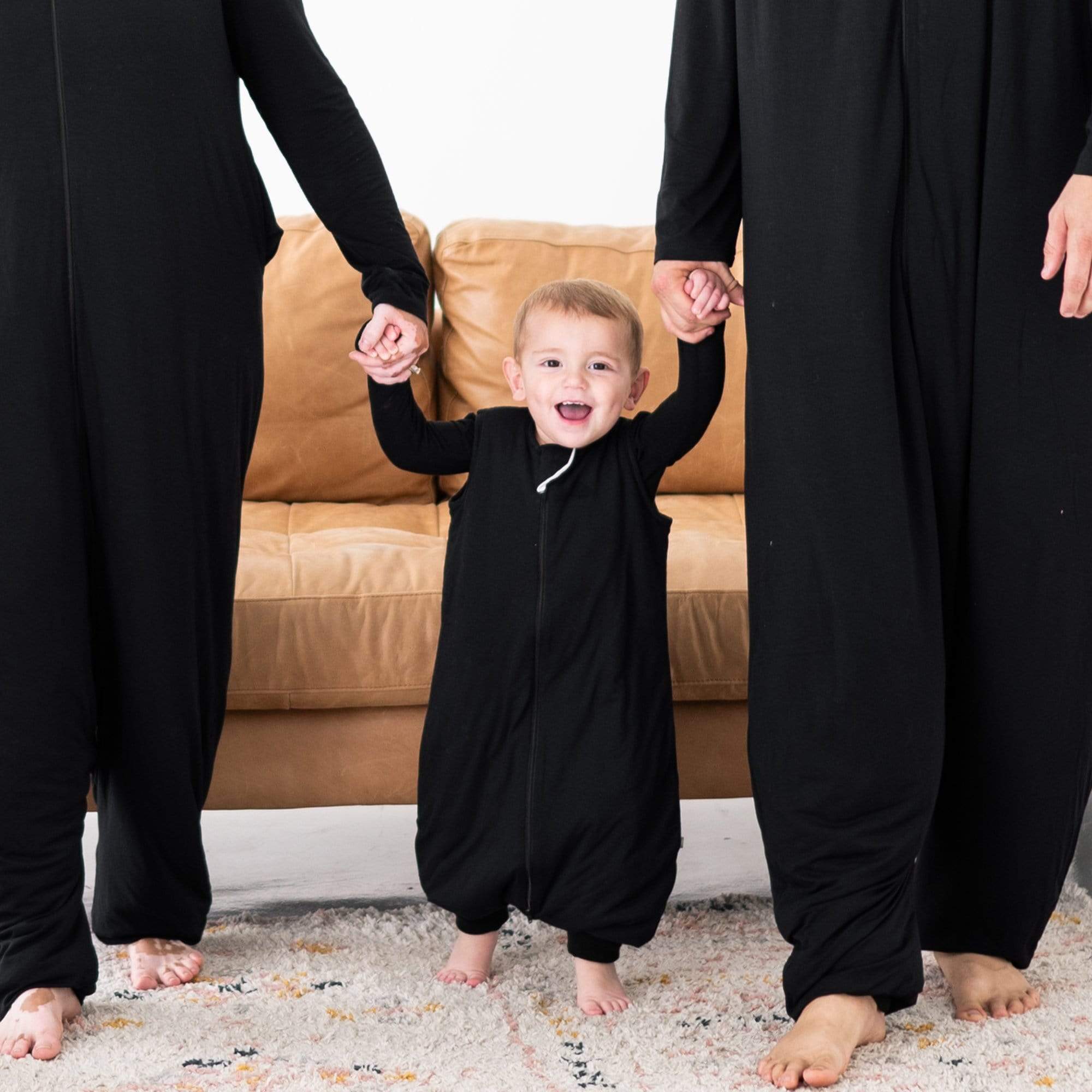 Family wearing adult and kids matching Kyte Baby Sleep Bag Walker in Midnight 2.5