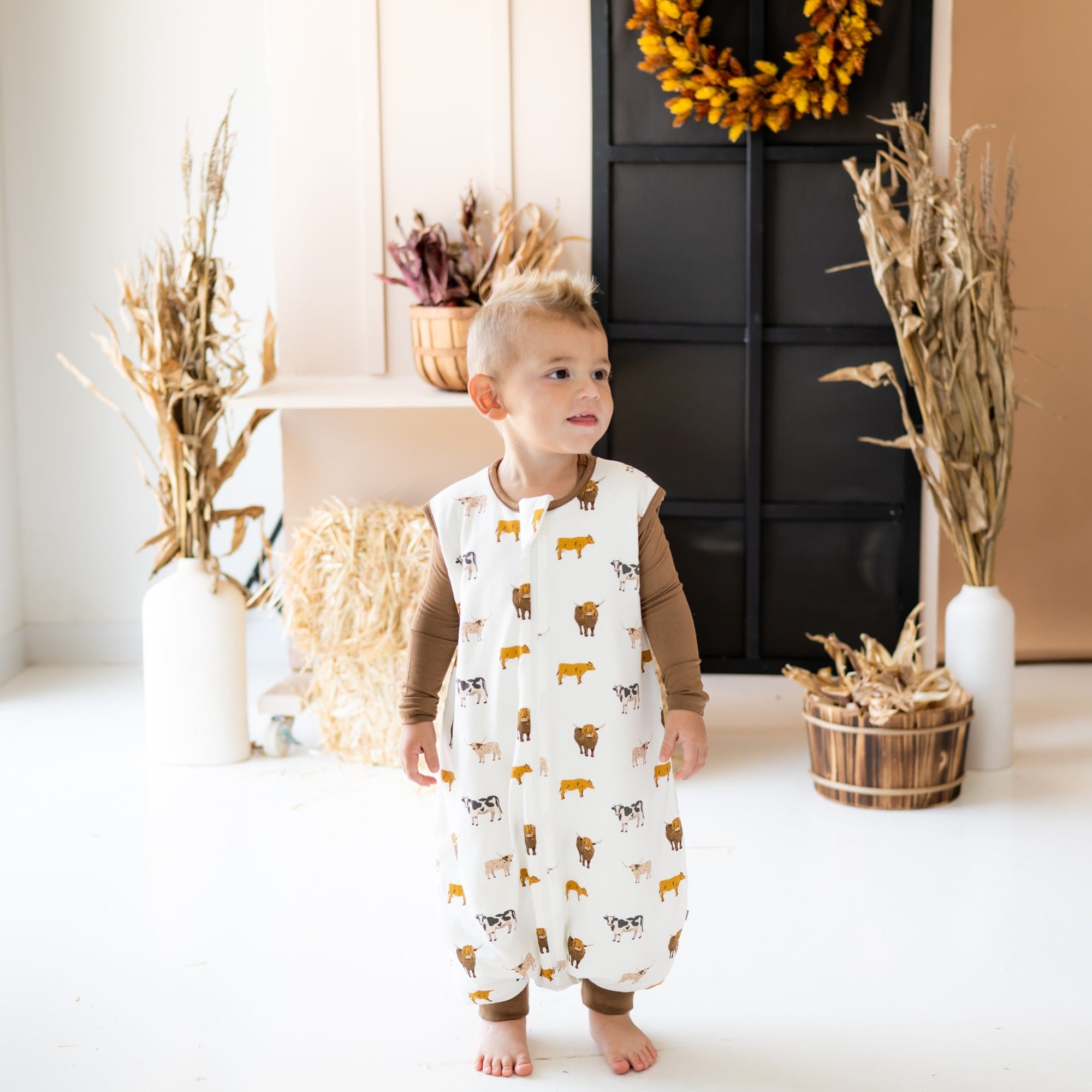 Child wearing Kyte Baby bamboo Sleep Bag Walker in Moo 1.0