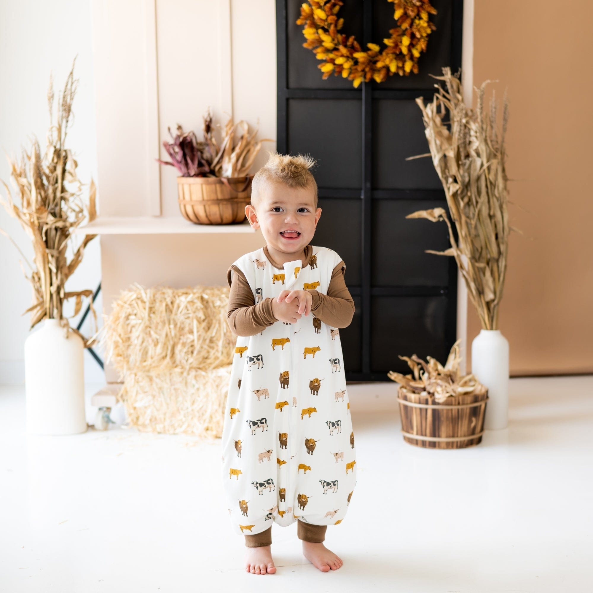 Toddler wearing Kyte Baby Sleep Bag Walker in Moo 1.0