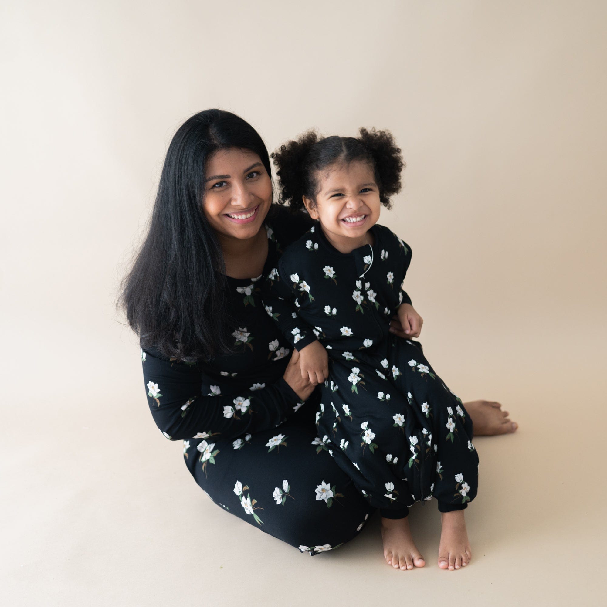 Mom and daughter in matching Kyte Baby Sleep Bag Walkers in TOG 1.0 Small Midnight Magnolia print