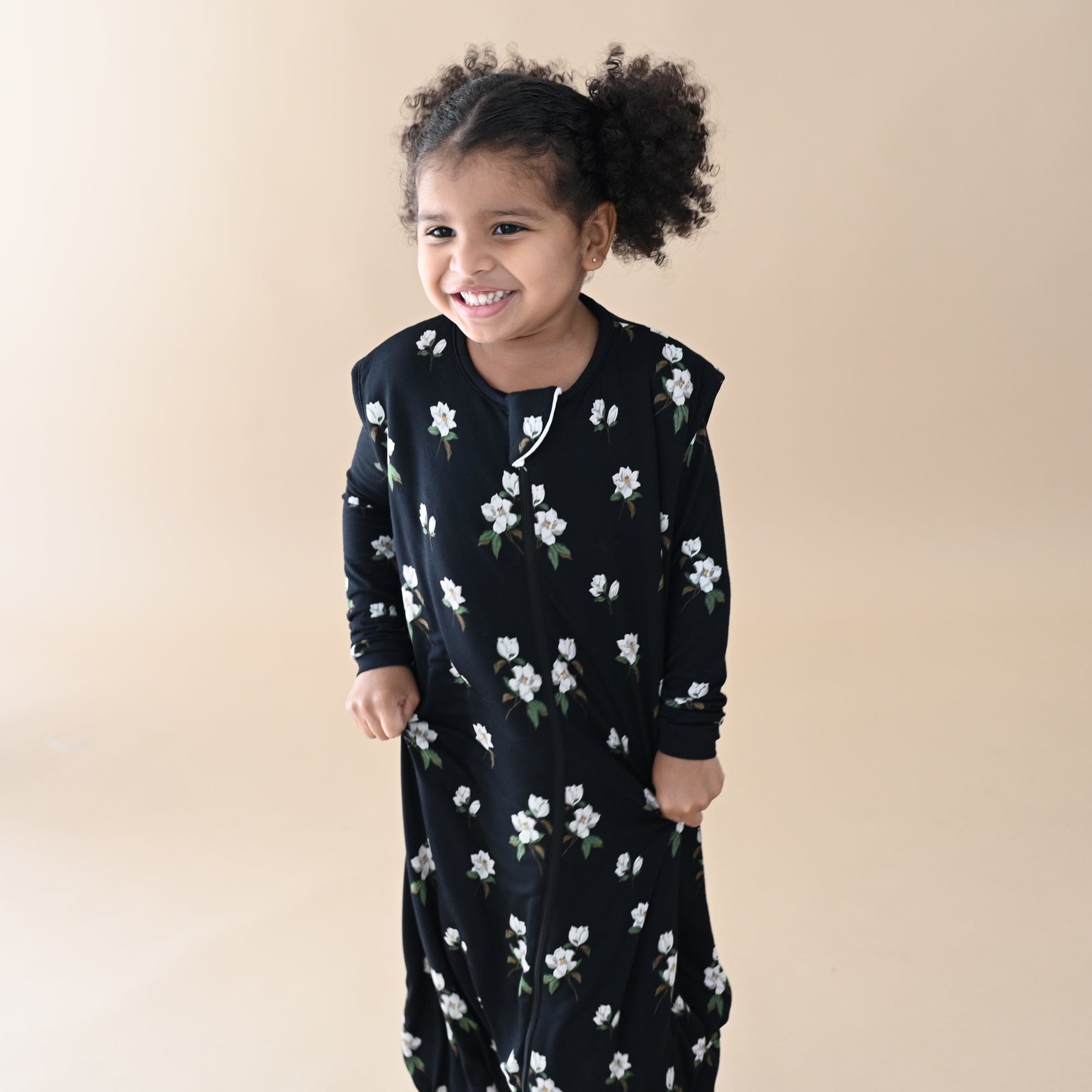 Child wearing Kyte Baby bamboo Sleep Bag Walker in Small Midnight Magnolia 1.0