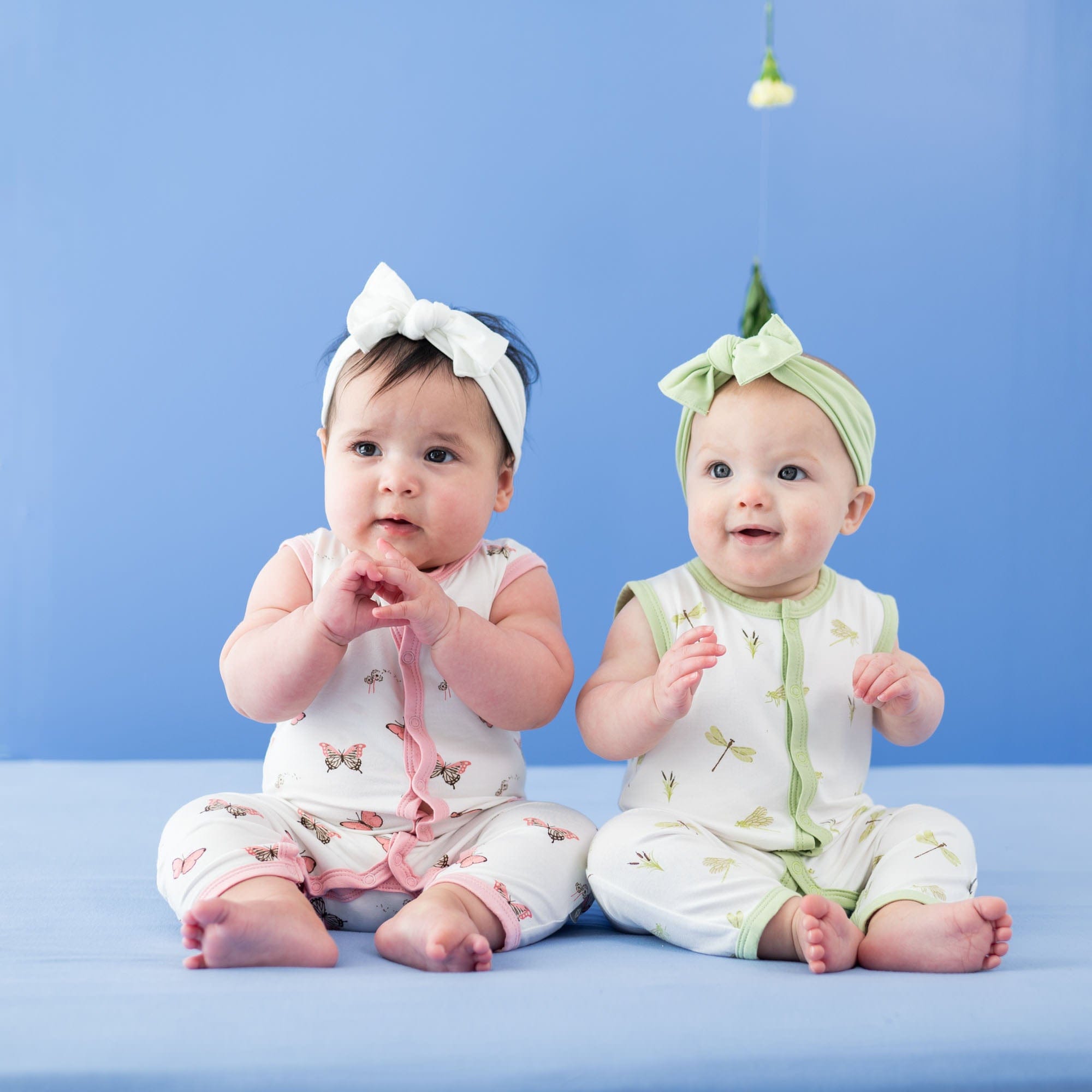 Infants wearing Kyte Baby Sleeveless capri Romper in Butterfly and Dragonfly