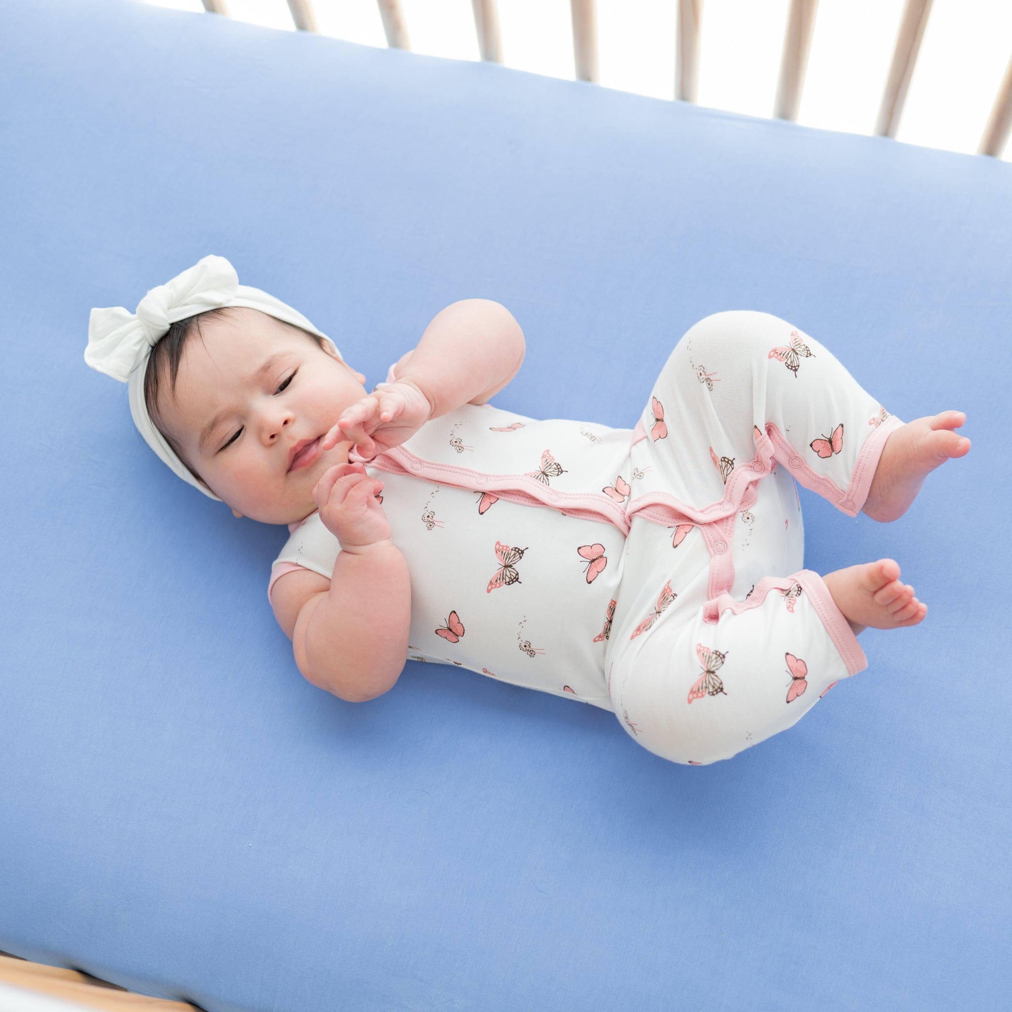 Child wearing bamboo Kyte Baby Sleeveless Romper in Butterfly