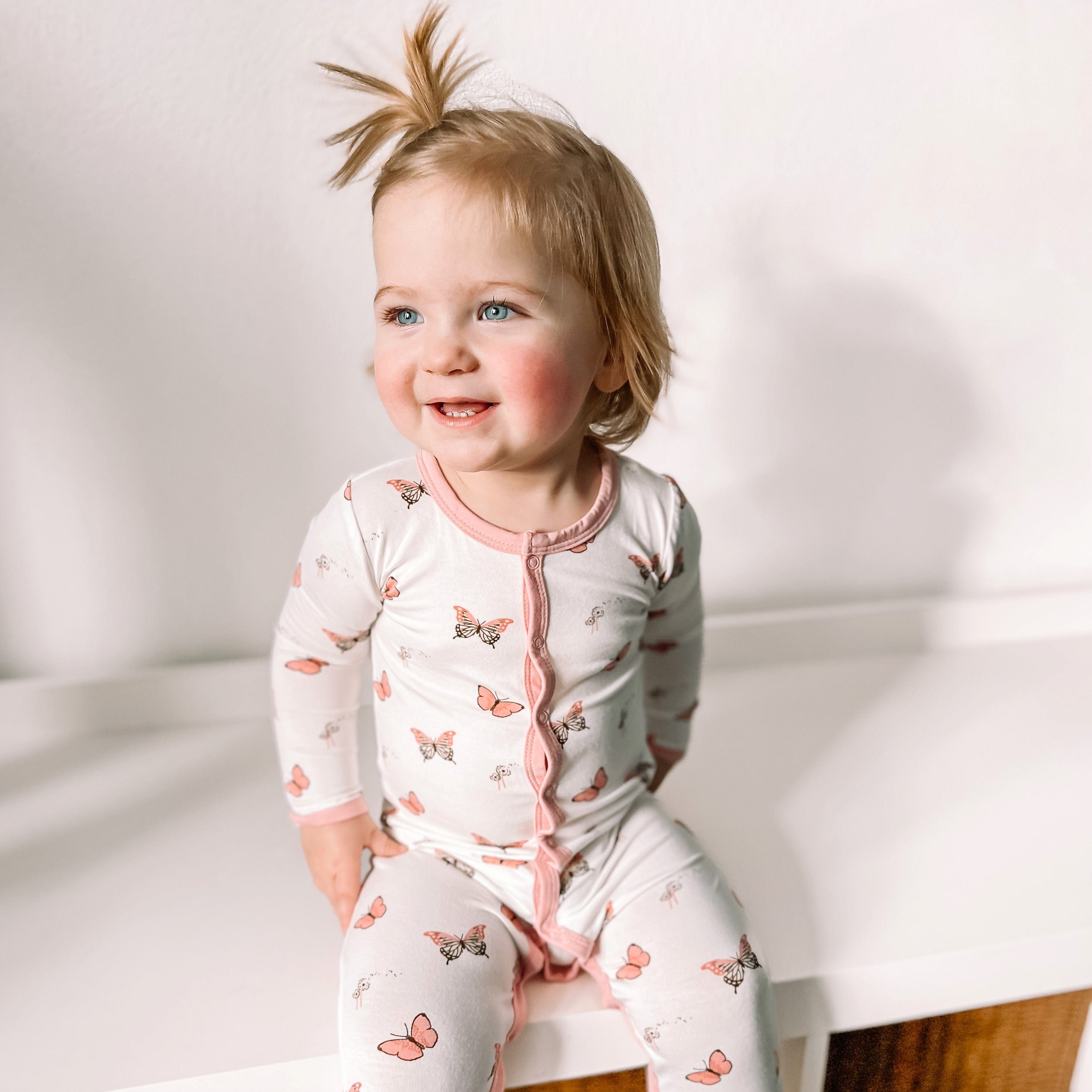 Toddler wearing Kyte Baby Snap Footie pajamas in Butterfly