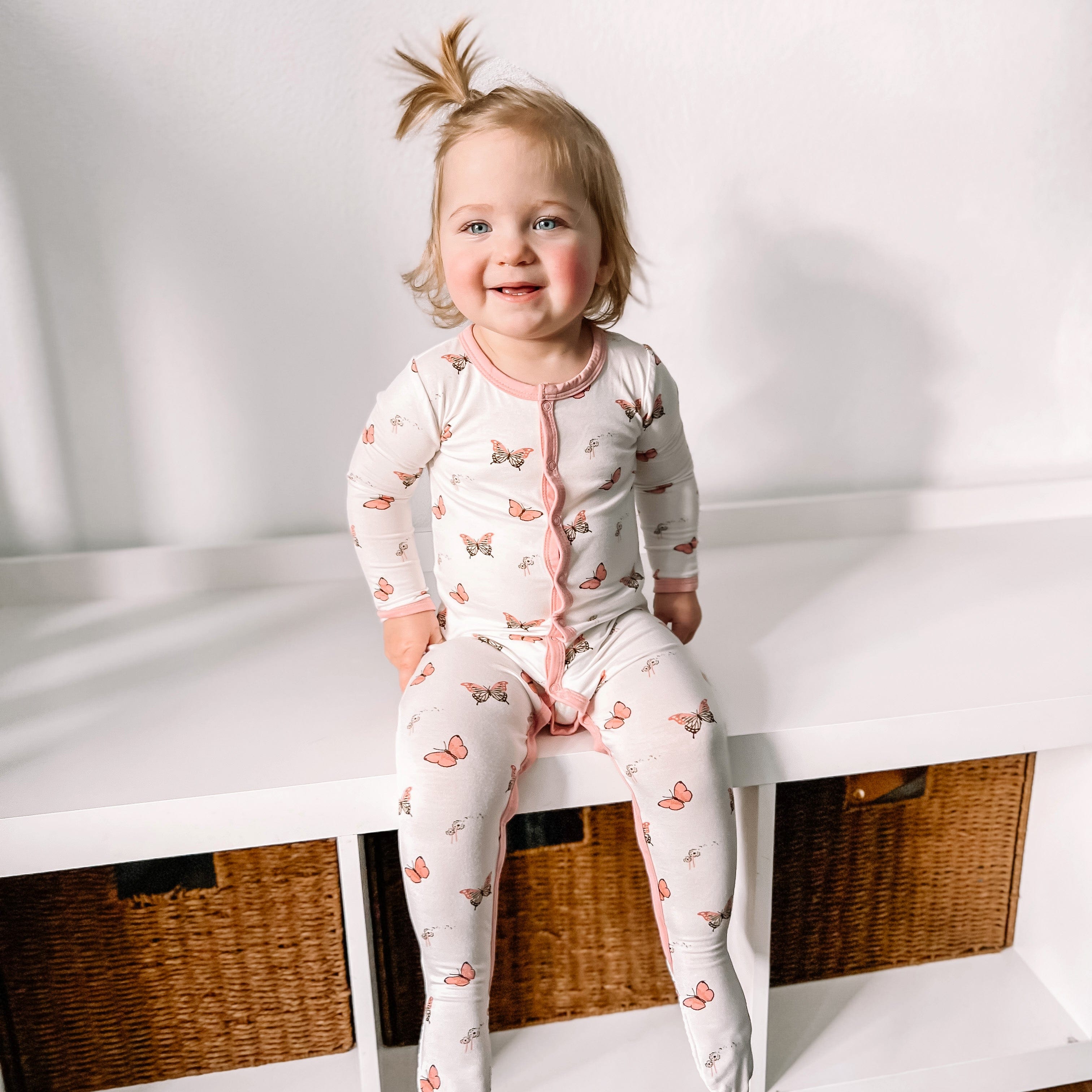 Toddler wearing Kyte Baby Footie in Butterfly
