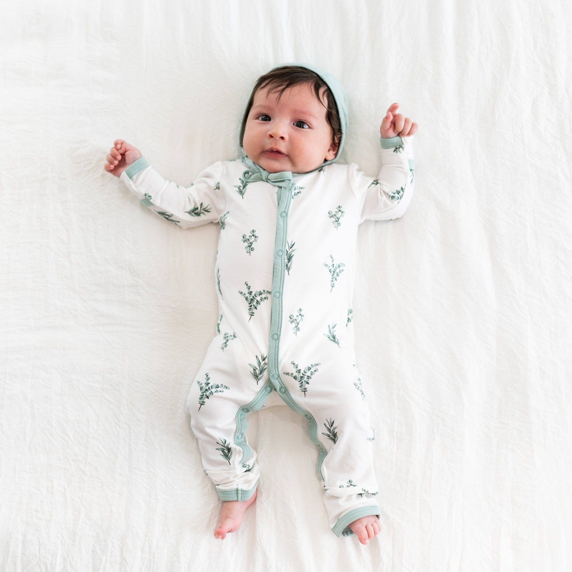 Infant wearing Kyte Baby Romper in Eucalyptus