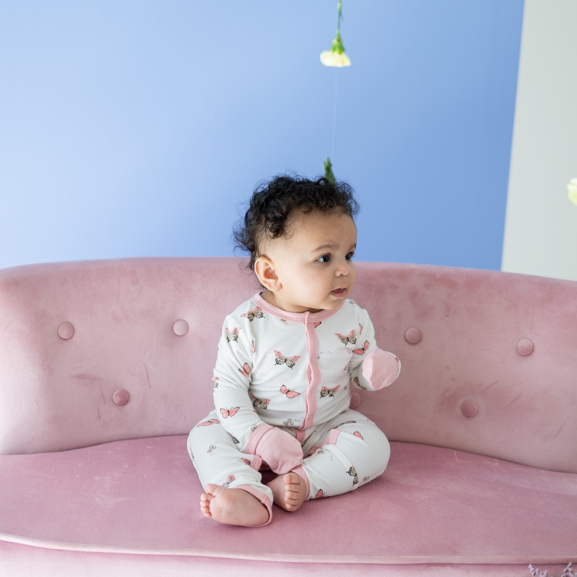 Child wearing long sleeve Kyte Baby Romper with snaps in Butterfly