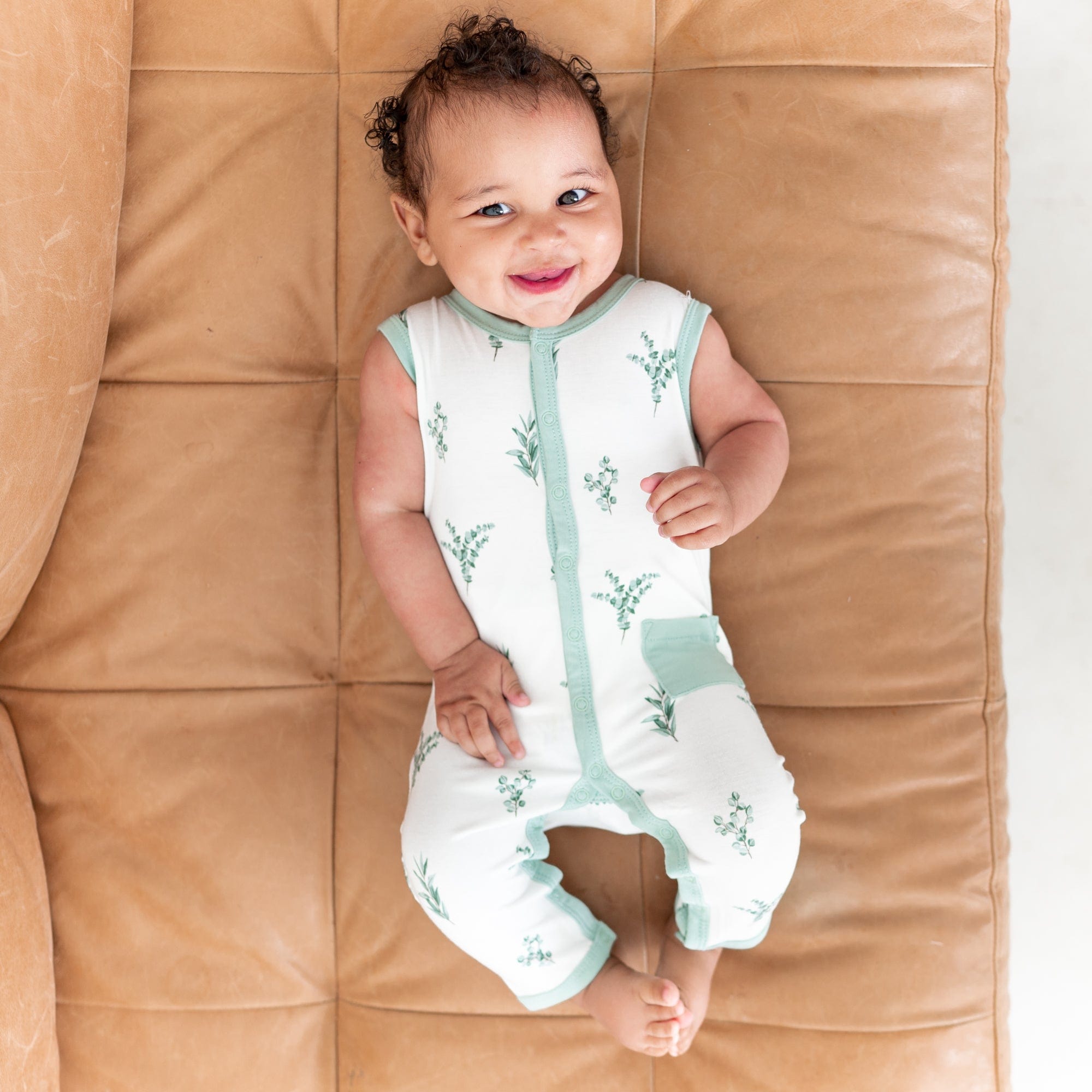 Child wearing bamboo Kyte Baby Sleeveless Romper in Eucalyptus
