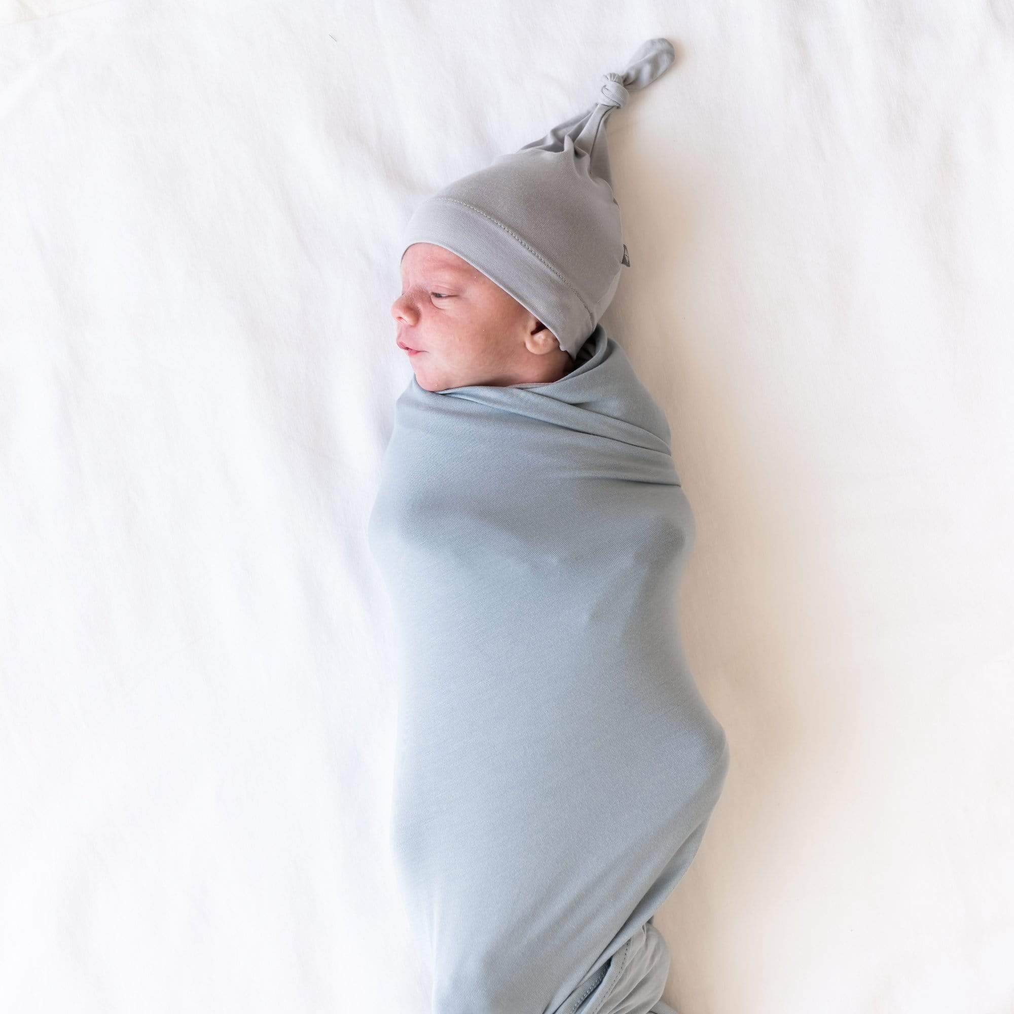 Infant swaddled in bamboo Kyte Baby Swaddle Blanket in Fog