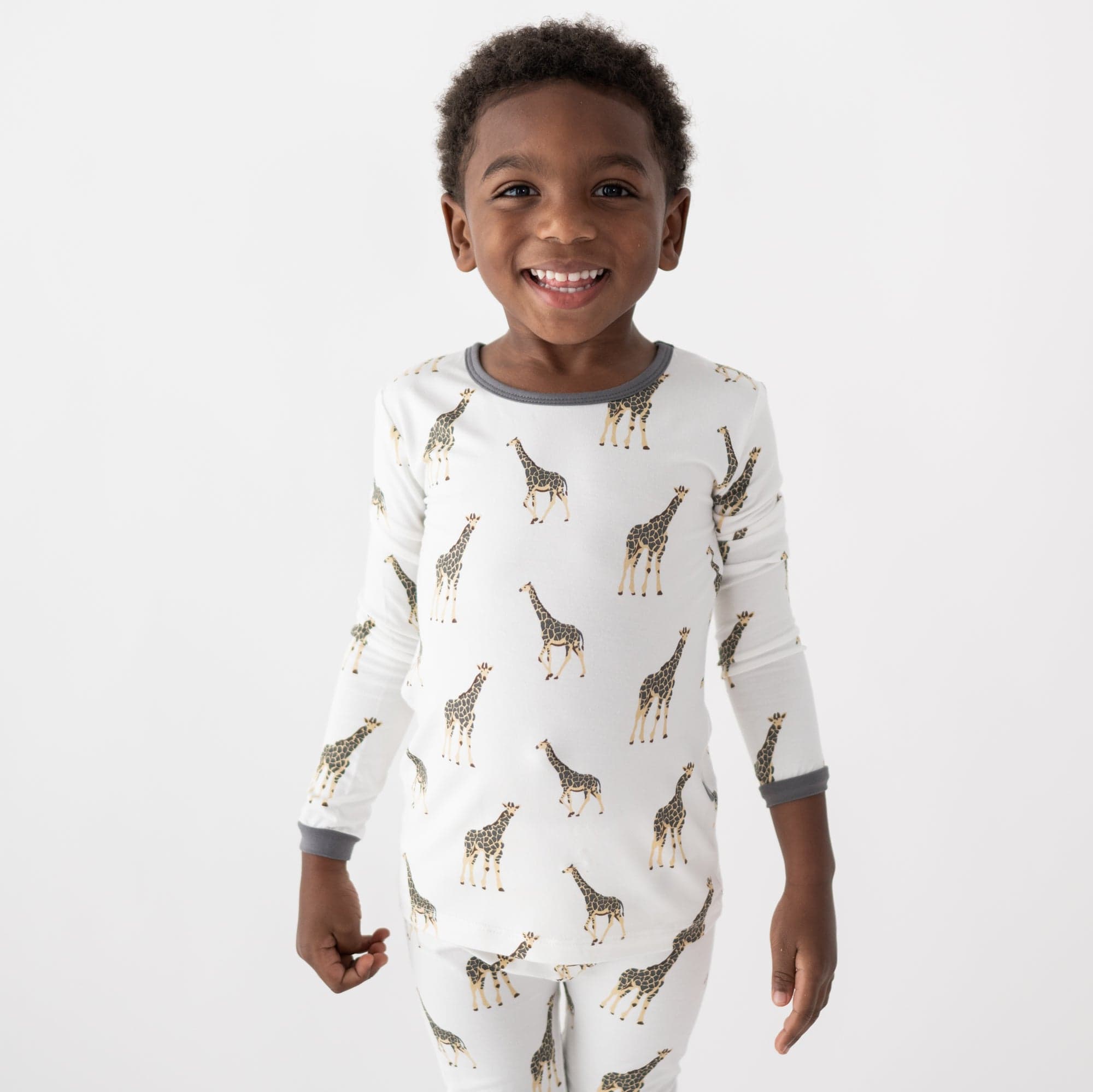 Toddler wearing Kyte Baby bamboo Long Sleeve Pajamas in Giraffe