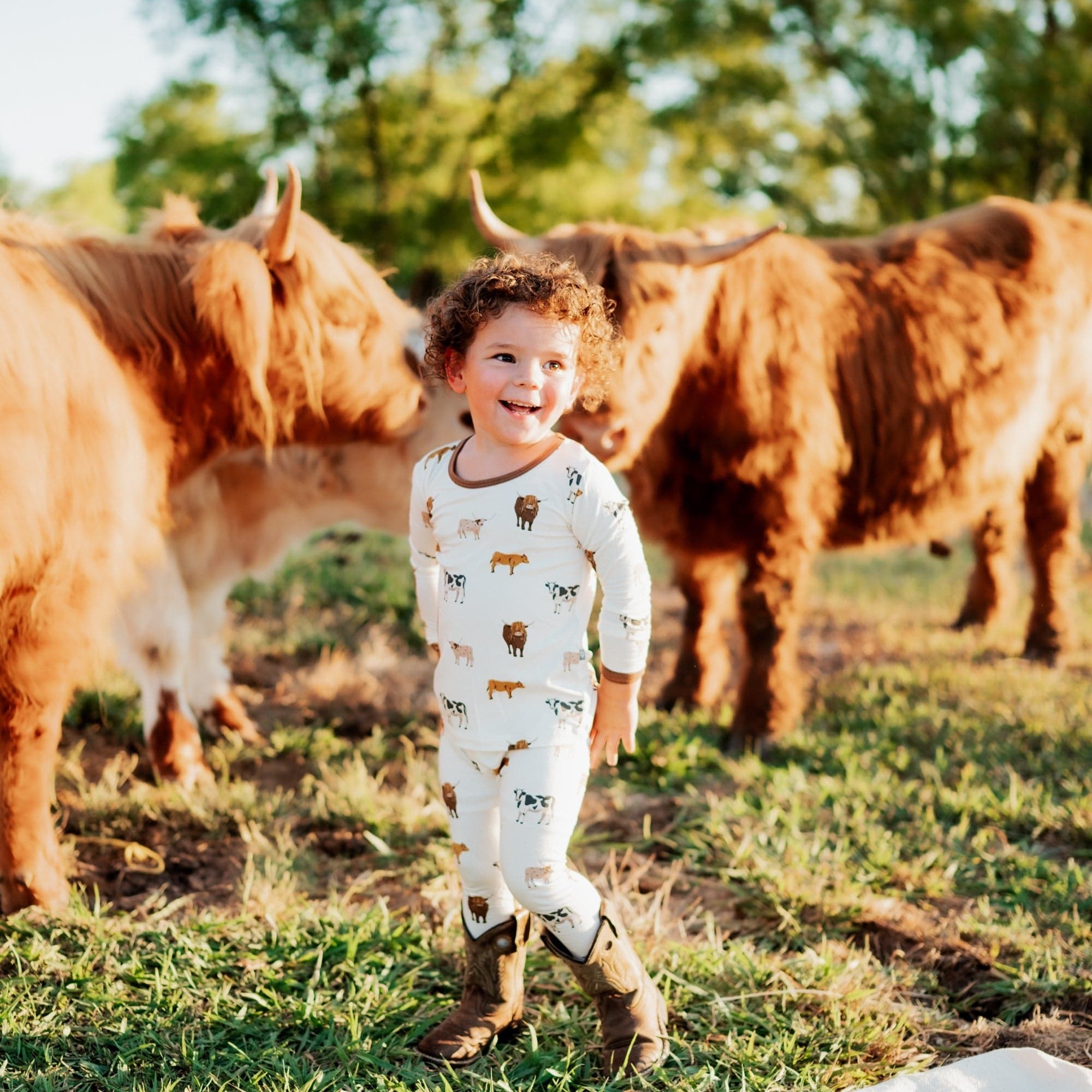Toddler wearing Kyte Baby Long Sleeve Pajamas in Moo