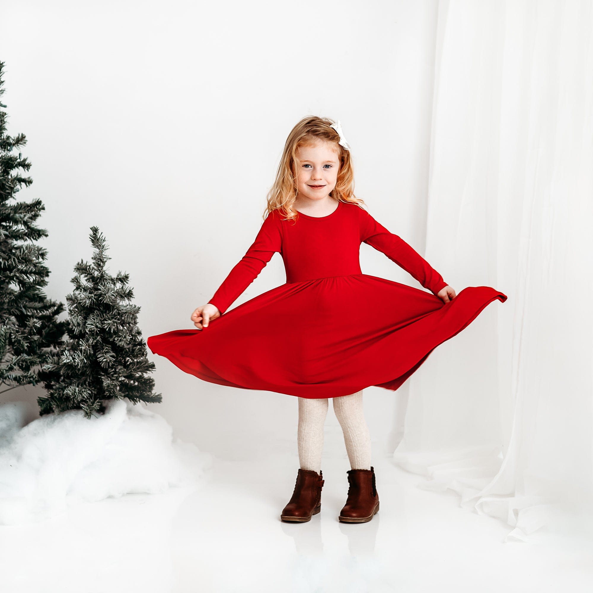 Girl wearing Kyte Baby Long Sleeve Twirl Dress in Cardinal