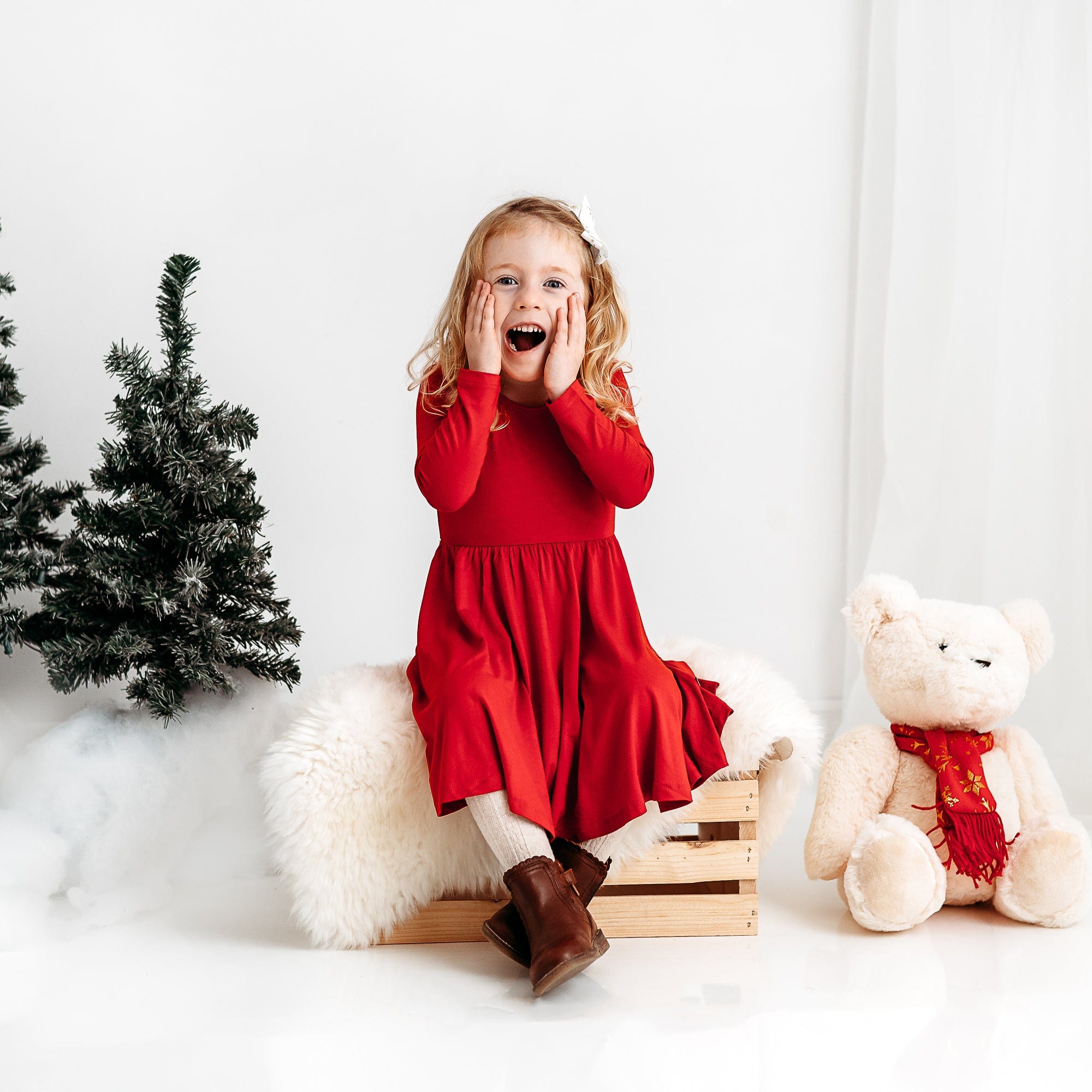 Toddler wearing Kyte Baby bamboo Long Sleeve Twirl Dress in Cardinal red