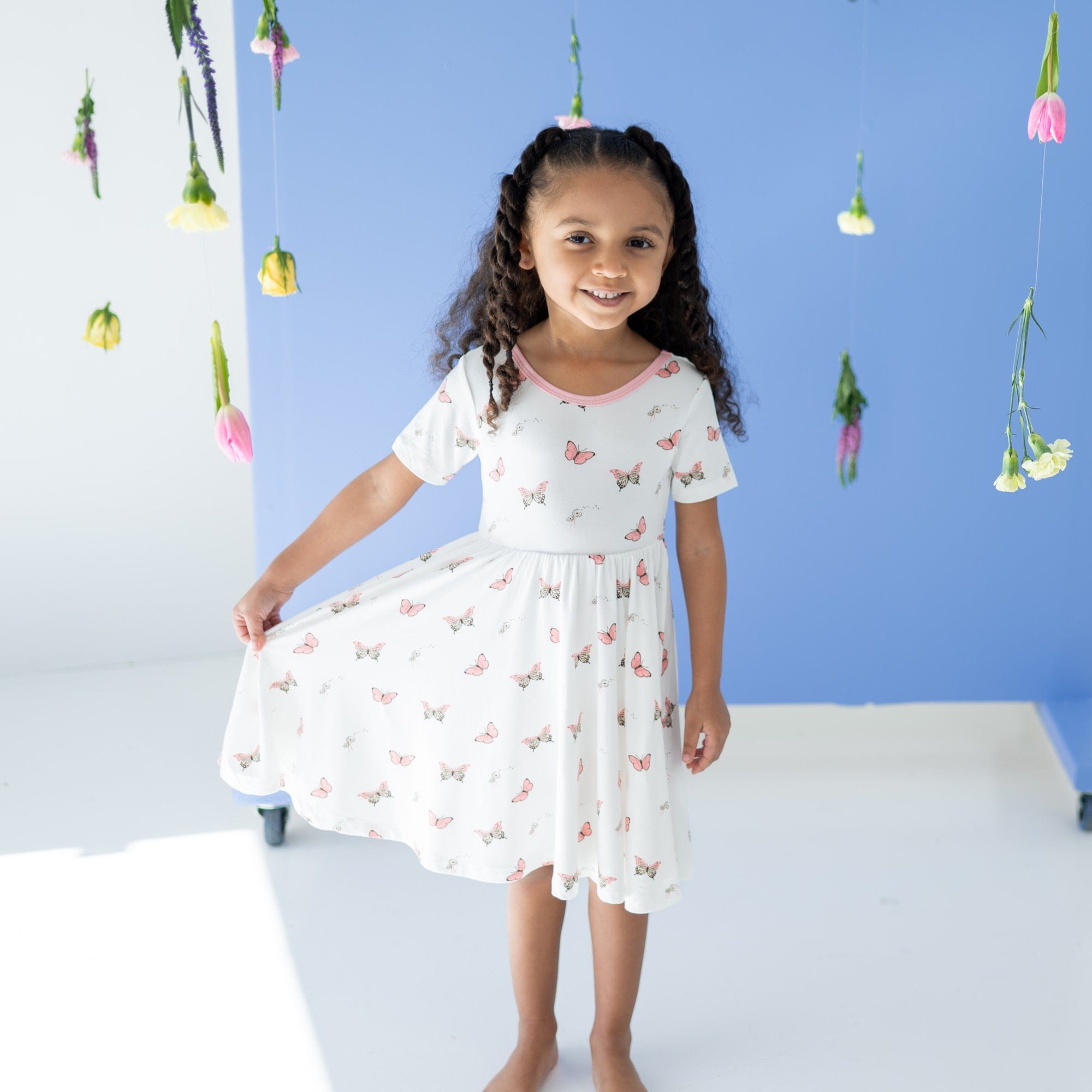 Girl wearing Kyte Baby Twirl Dress in Butterfly