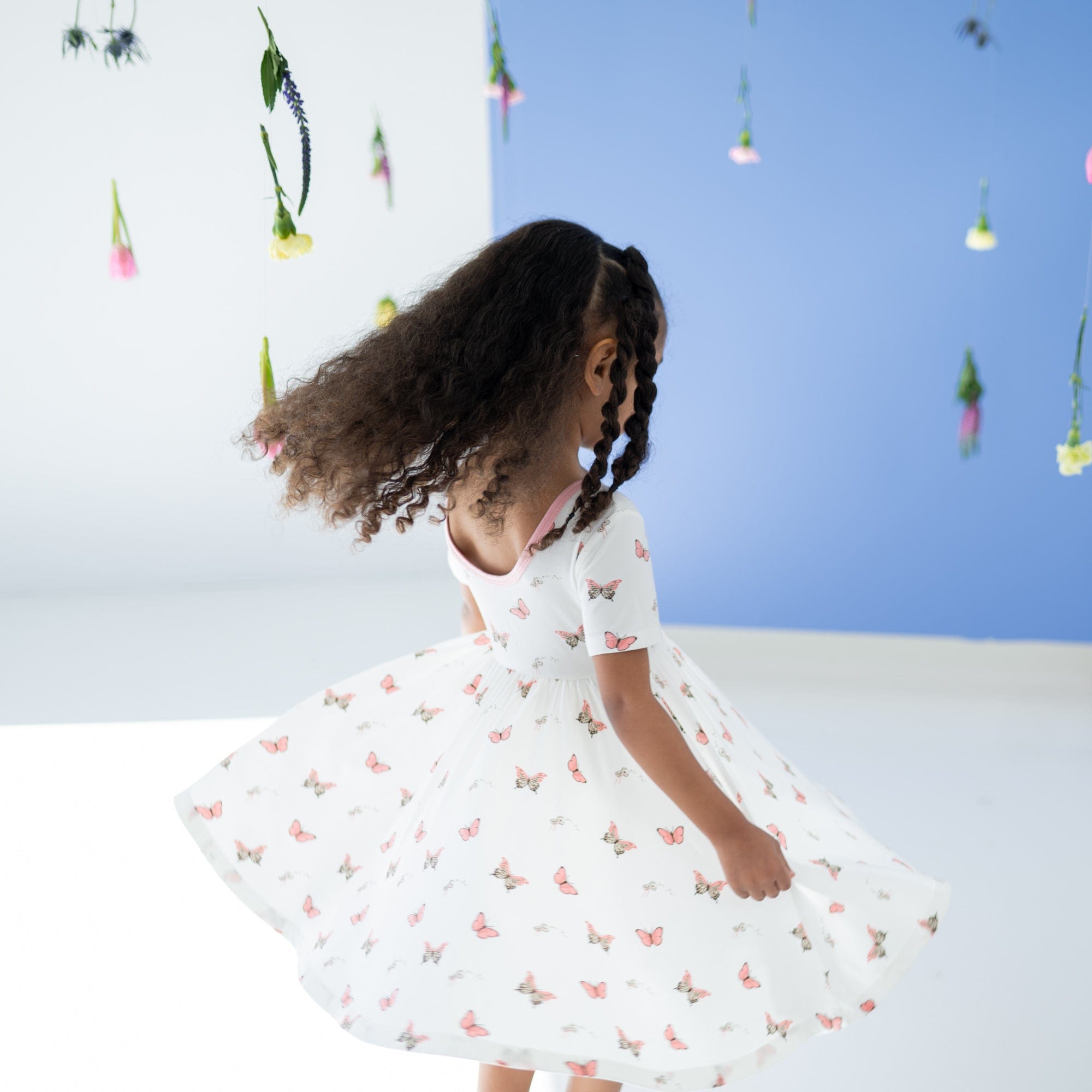 Toddler twirling in Kyte Baby Twirl Dress in Butterfly