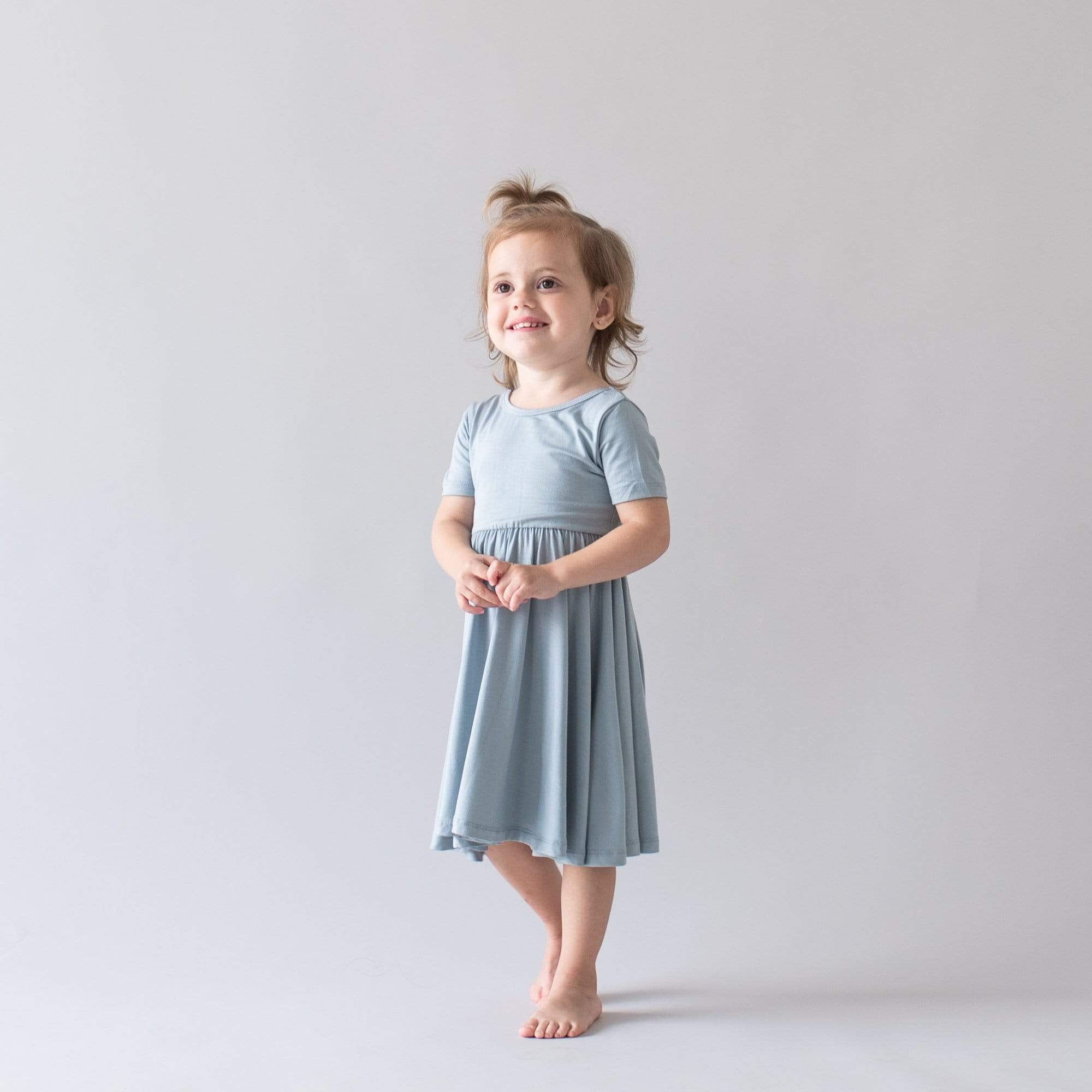 Girl wearing Kyte Baby Twirl Dress in Fog