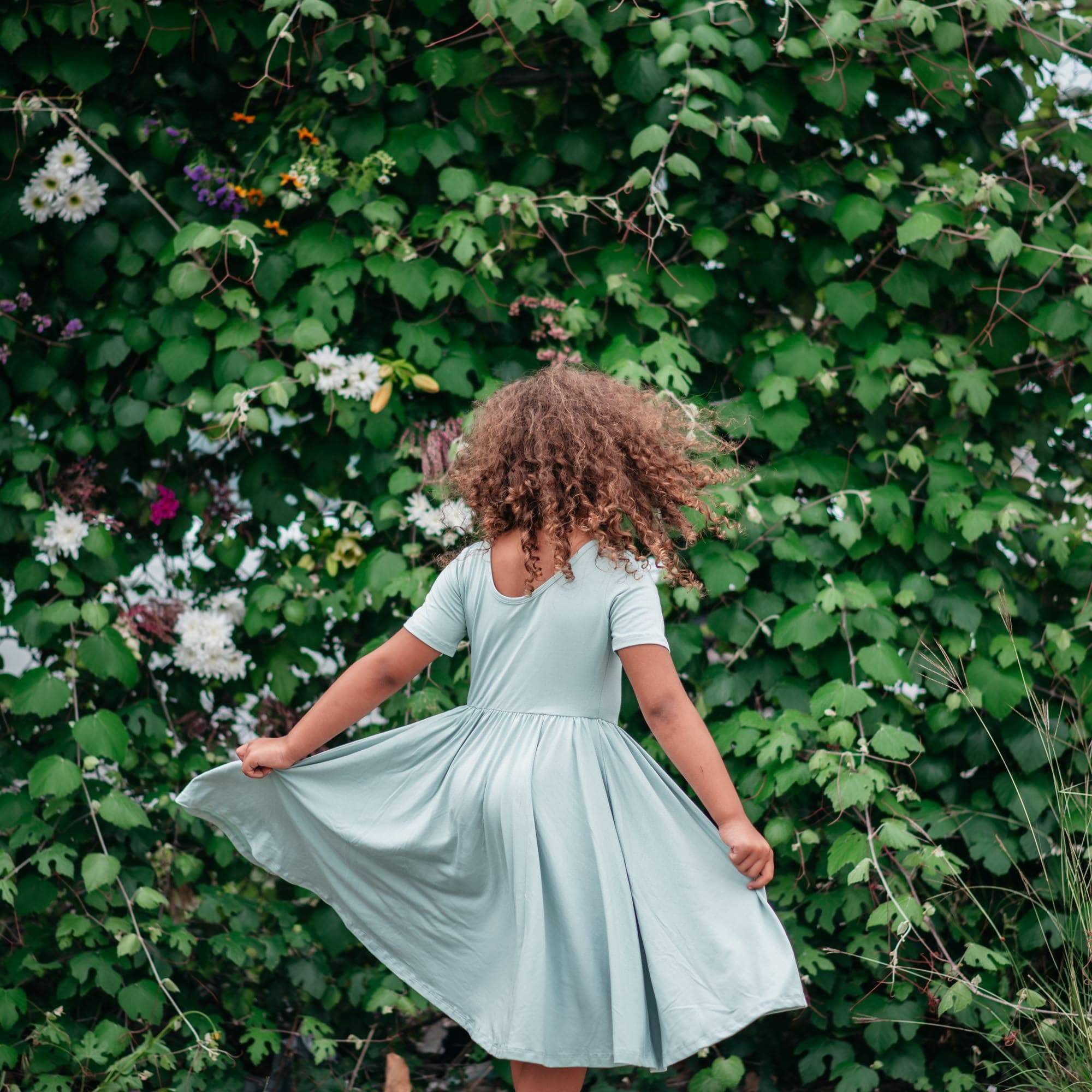 Toddler wearing Kyte Baby Twirl Dress in Sage