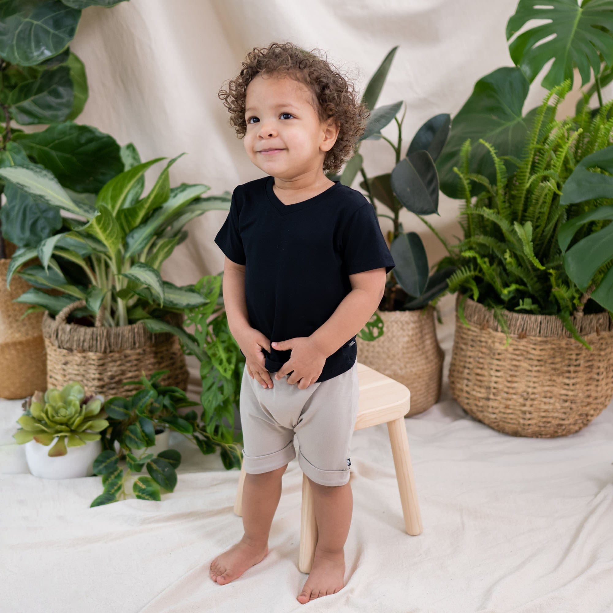 Child wearing Kyte Baby Toddler relaxed fit V-Neck Tee in Midnight black