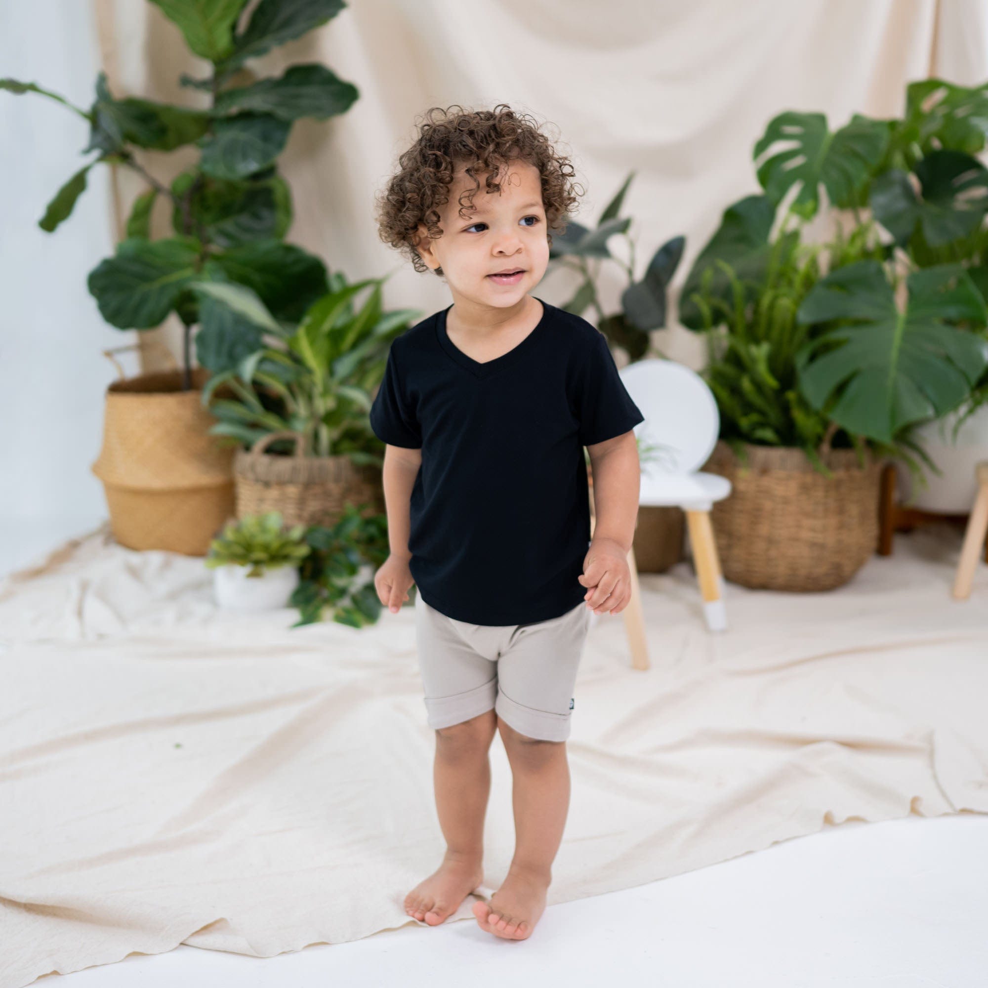 Boy wearing Kyte Baby Toddler V-Neck Tee in Midnight