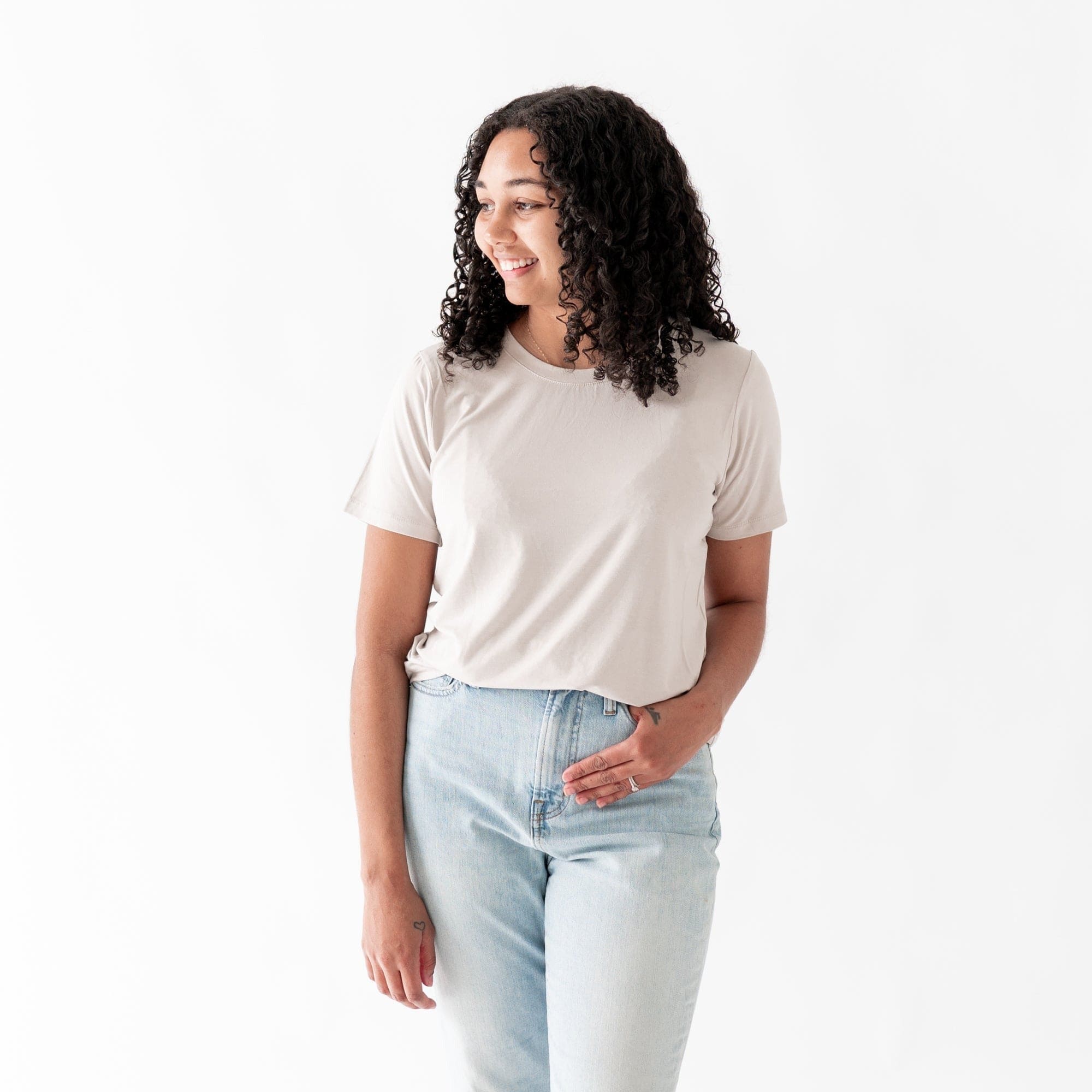Woman wearing Kyte Baby Women's relaxed fit Crew Neck Tee in Oat