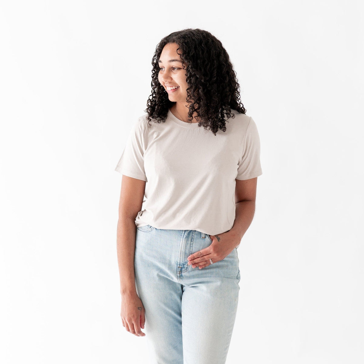 Woman wearing Kyte Baby Women's relaxed fit Crew Neck Tee in Oat