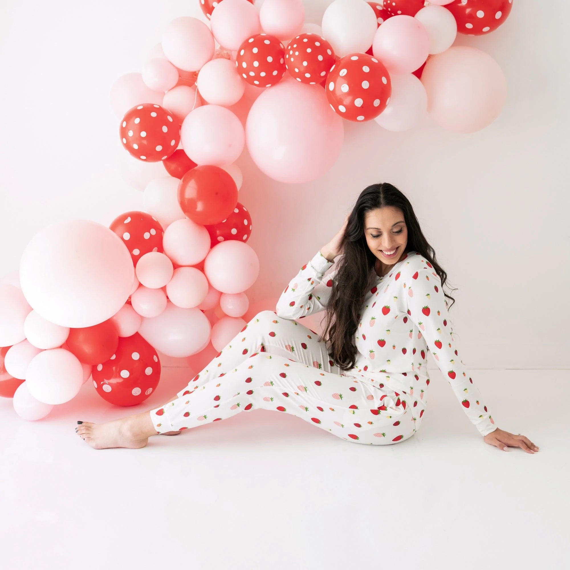 Woman wearing Kyte Baby women's jogger pajama set in Strawberry