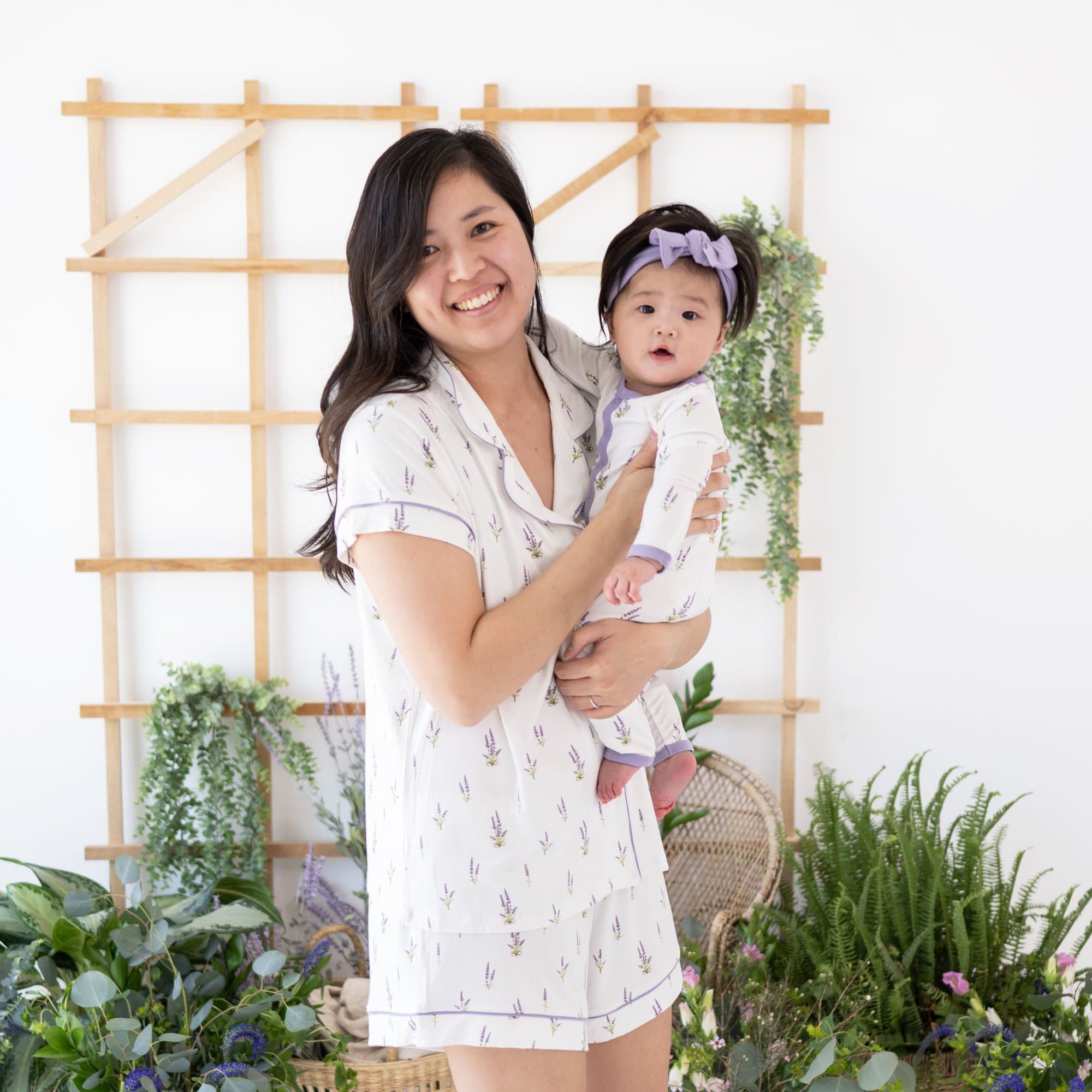 Mother and daughter in matching Kyte Baby pajamas in Lavender pattern