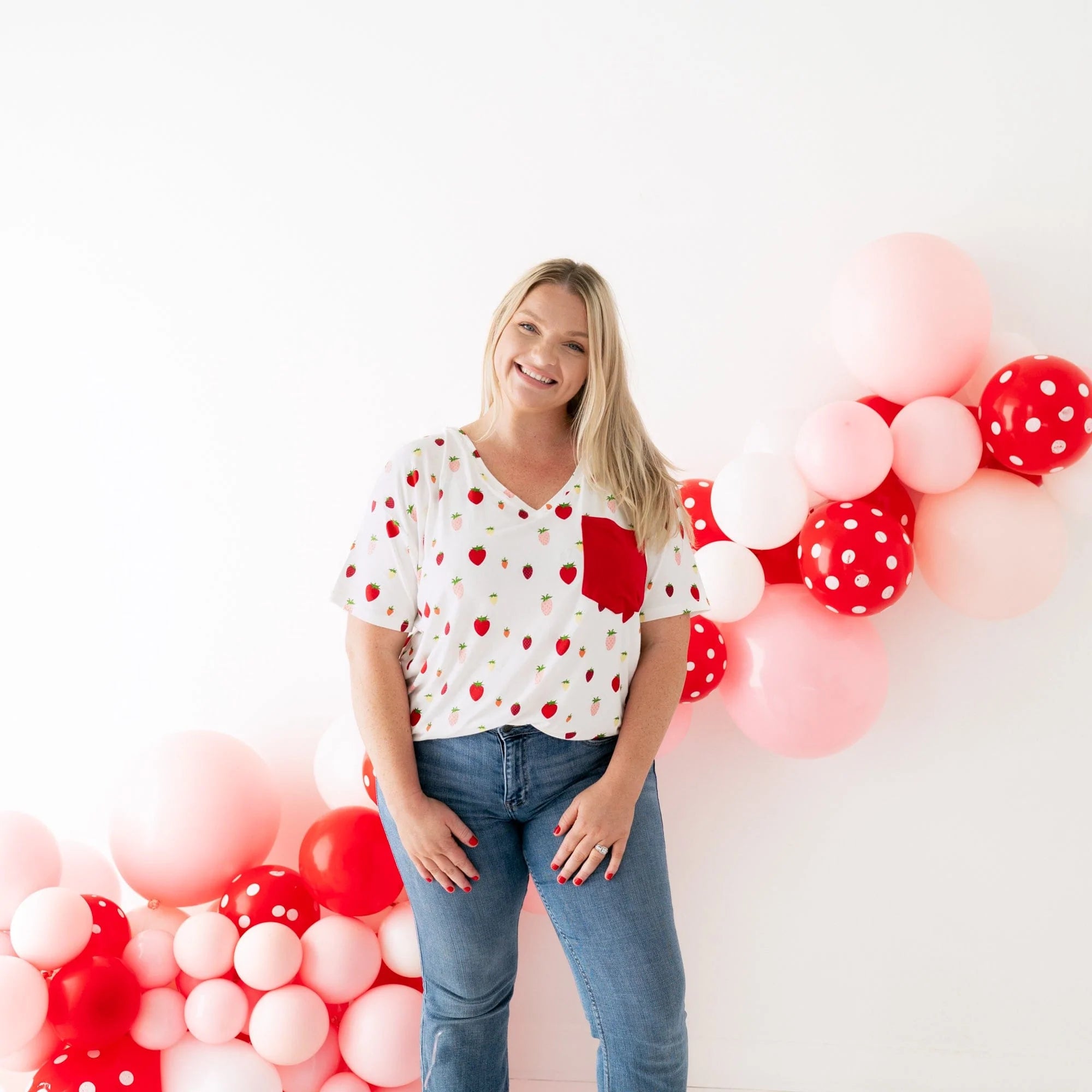 Woman wearing Kyte Baby Women's Relaxed Fit V-Neck in Strawberry