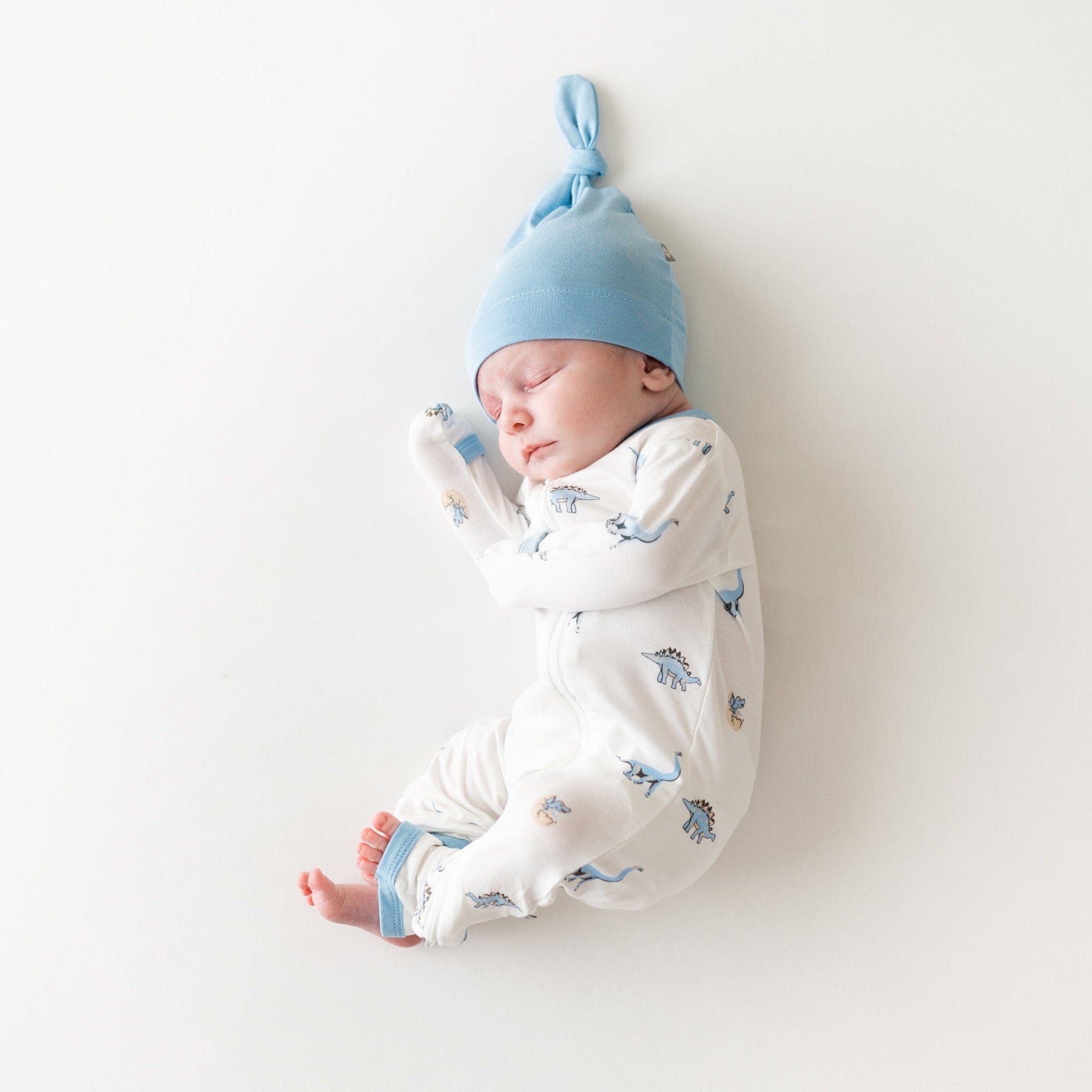 Newborn wearing Kyte Baby Zippered Romper in Jurassic