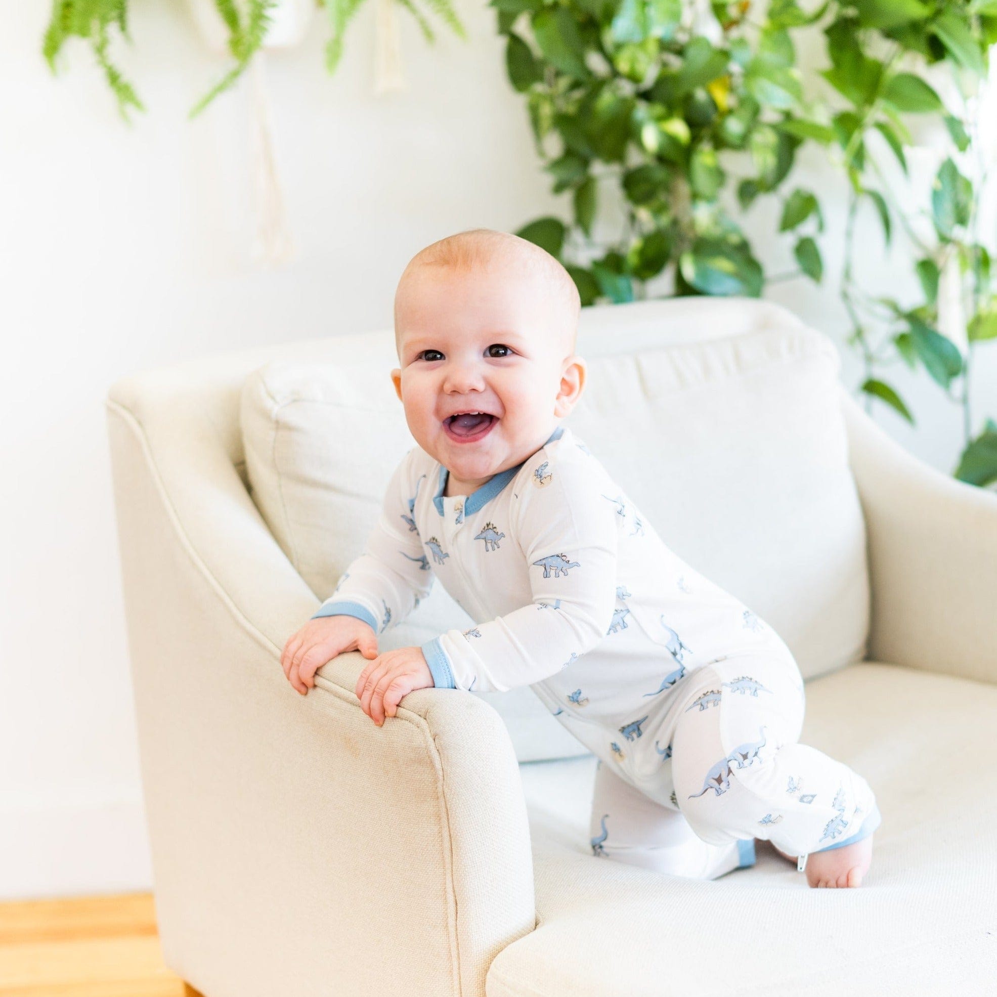 Infant wearing Kyte Baby Bamboo Zippered Romper in Jurassic