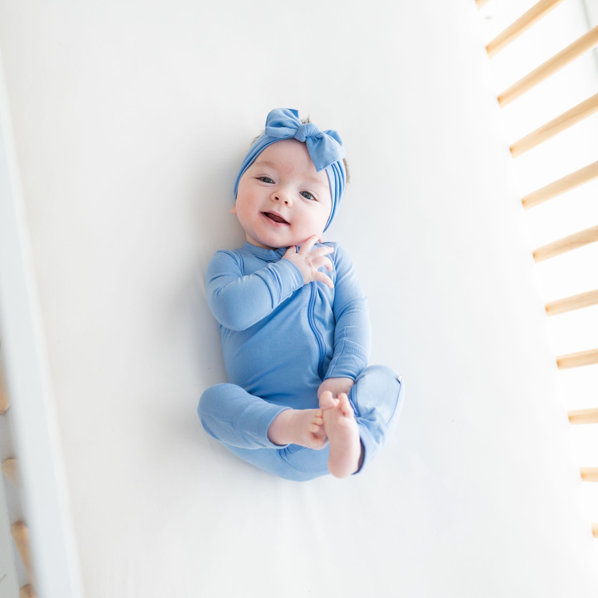 Baby wearing Kyte Baby bamboo Zippered Romper in Periwinkle