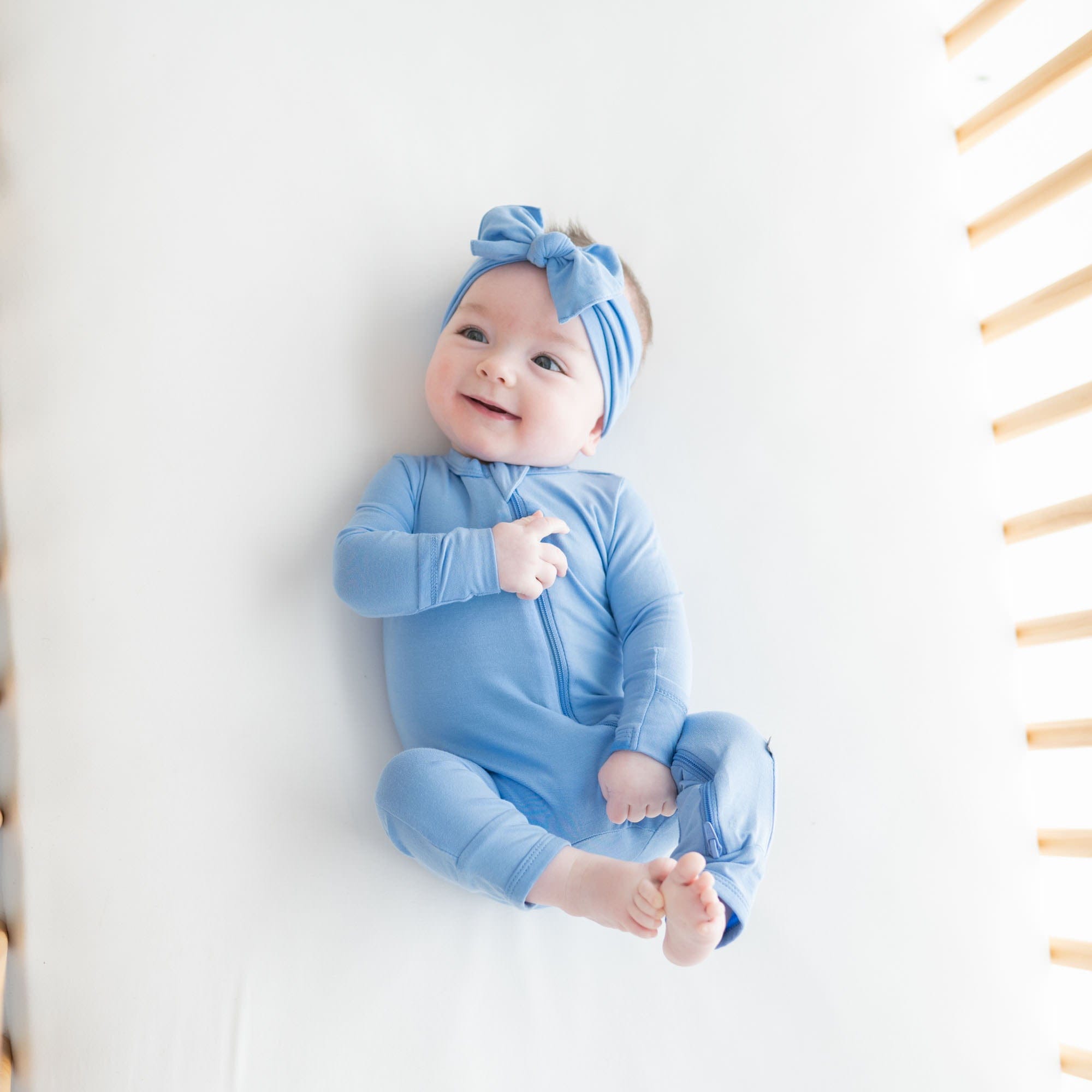 Infant wearing Kyte Baby Zippered Romper in Periwinkle