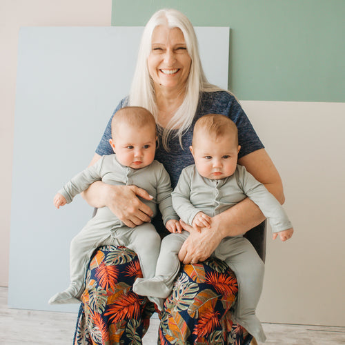 grandma holding twin grandchildren