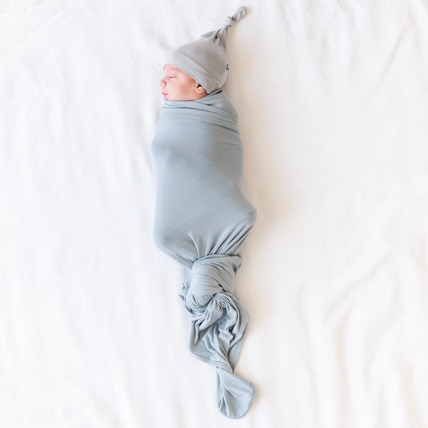 baby in a kyte baby seafoam swaddle