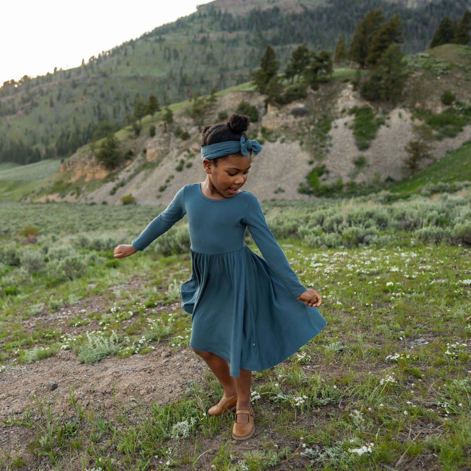 Girl twirls in Long Sleeve Dress with matching bow headband