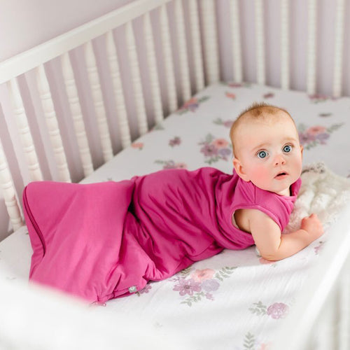 baby laying on her stomach in crib