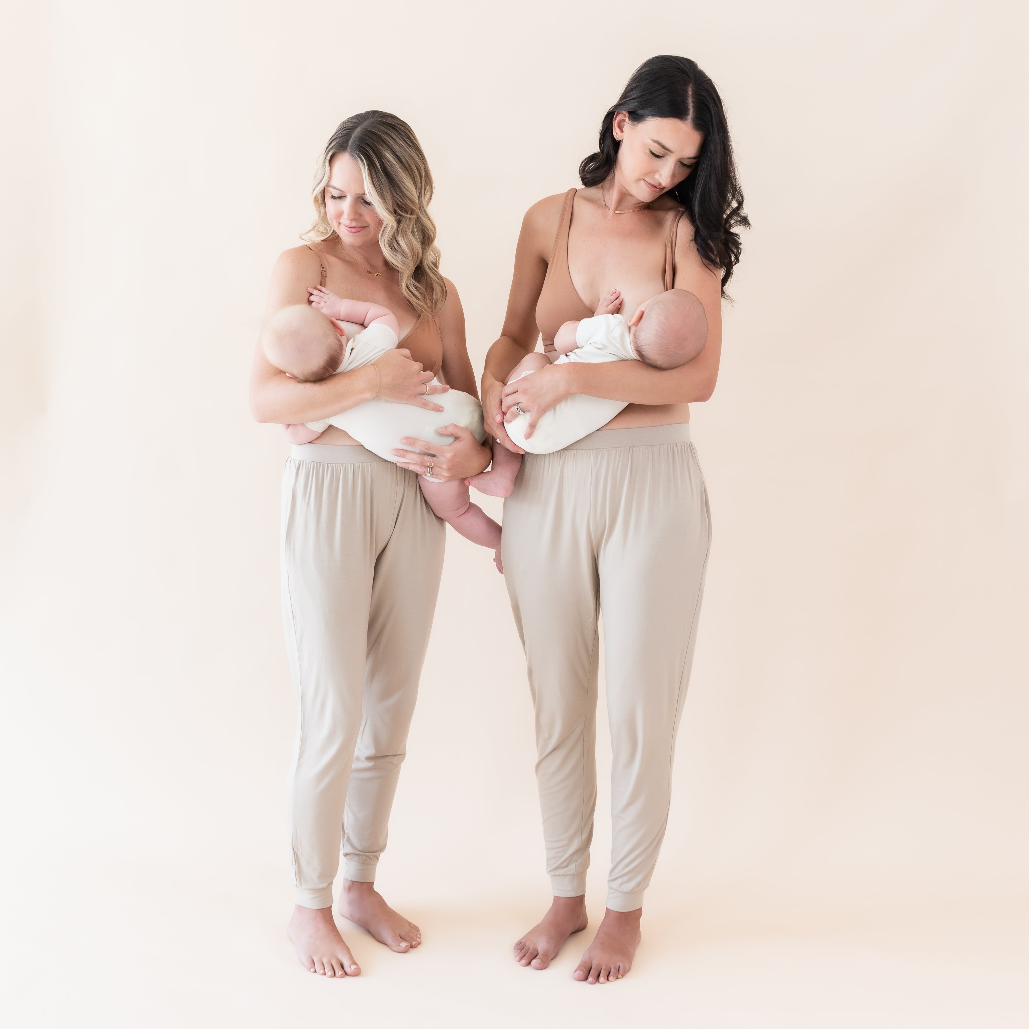 Moms nursing their newborns wearing Kyte Baby nursing bras