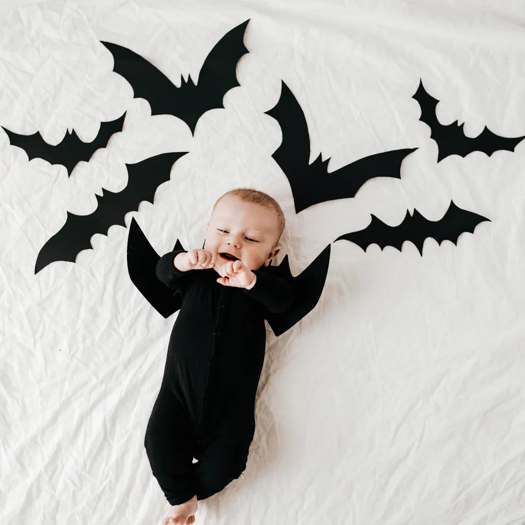 Baby in black romper for halloween bat costume