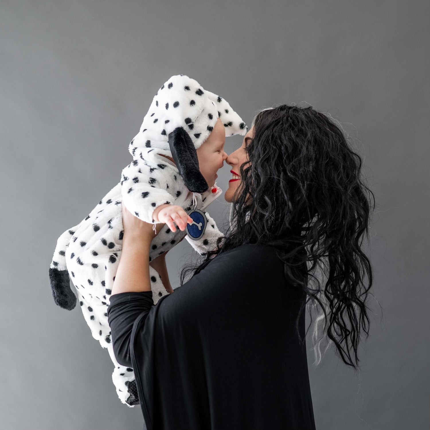 mom and baby dressed up as cruella deville and dalmation for halloween