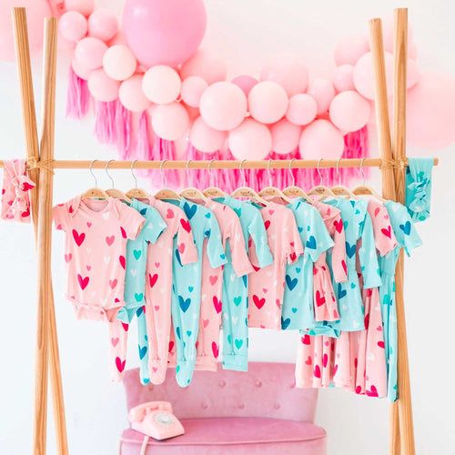 kyte baby valentine's day collection hanging on a rack with balloons