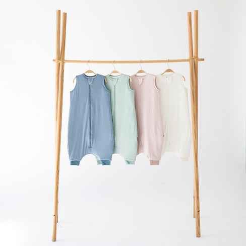 sleep bag walkers on a garment rack in colors slate, sage, blush and cloud