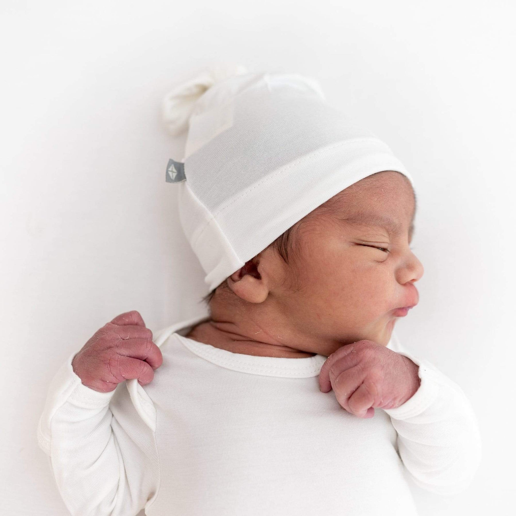 baby modeling knotted cap in cloud